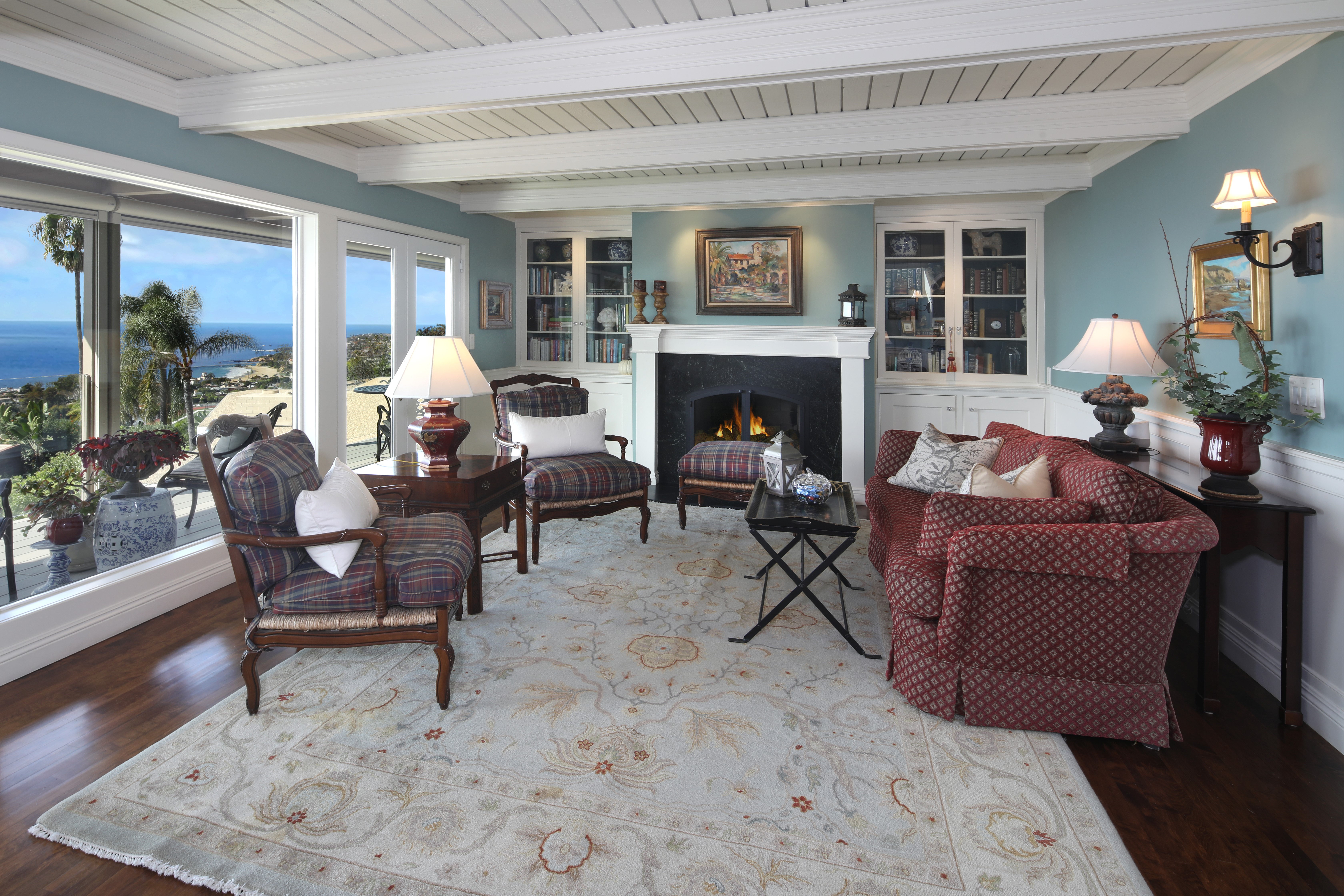 Living room with ocean view, sofa, and armchairs HD Wallpaper