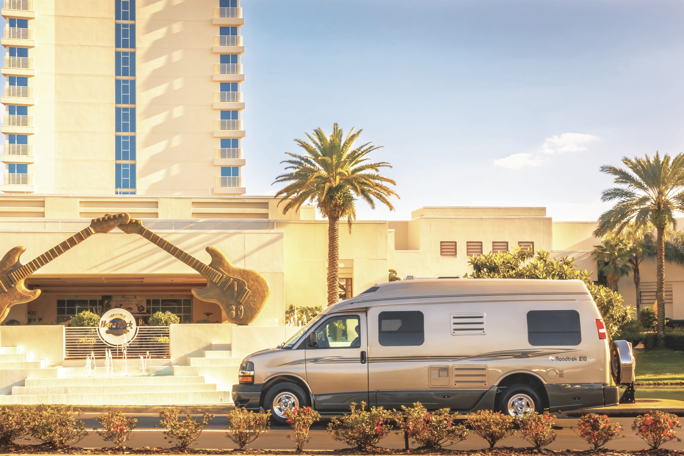 RV parked in front of Hard Rock Hotel with guitar sculptures HD Wallpaper