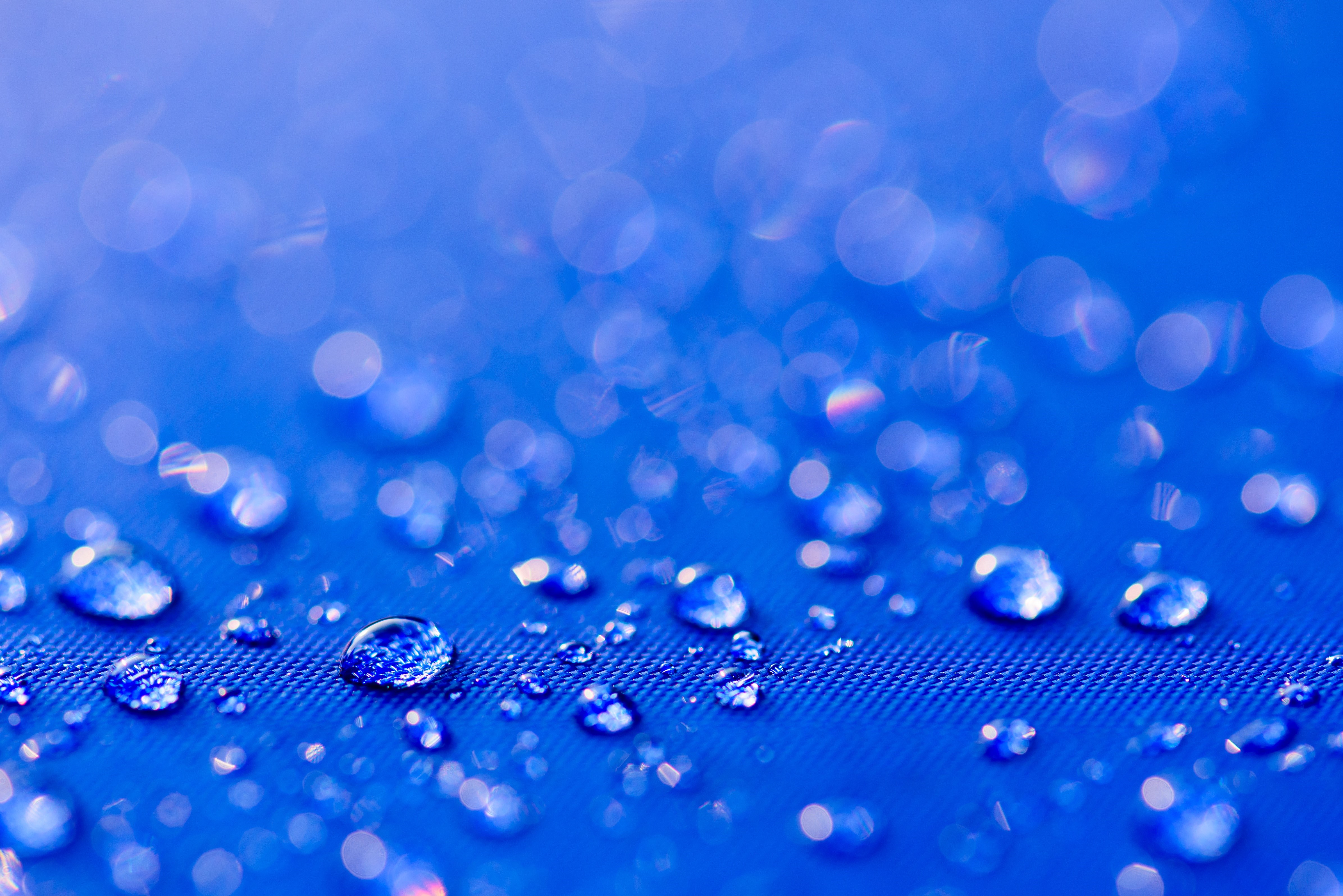 4K Closeup of Water Drops on Blue Surface HD Wallpaper