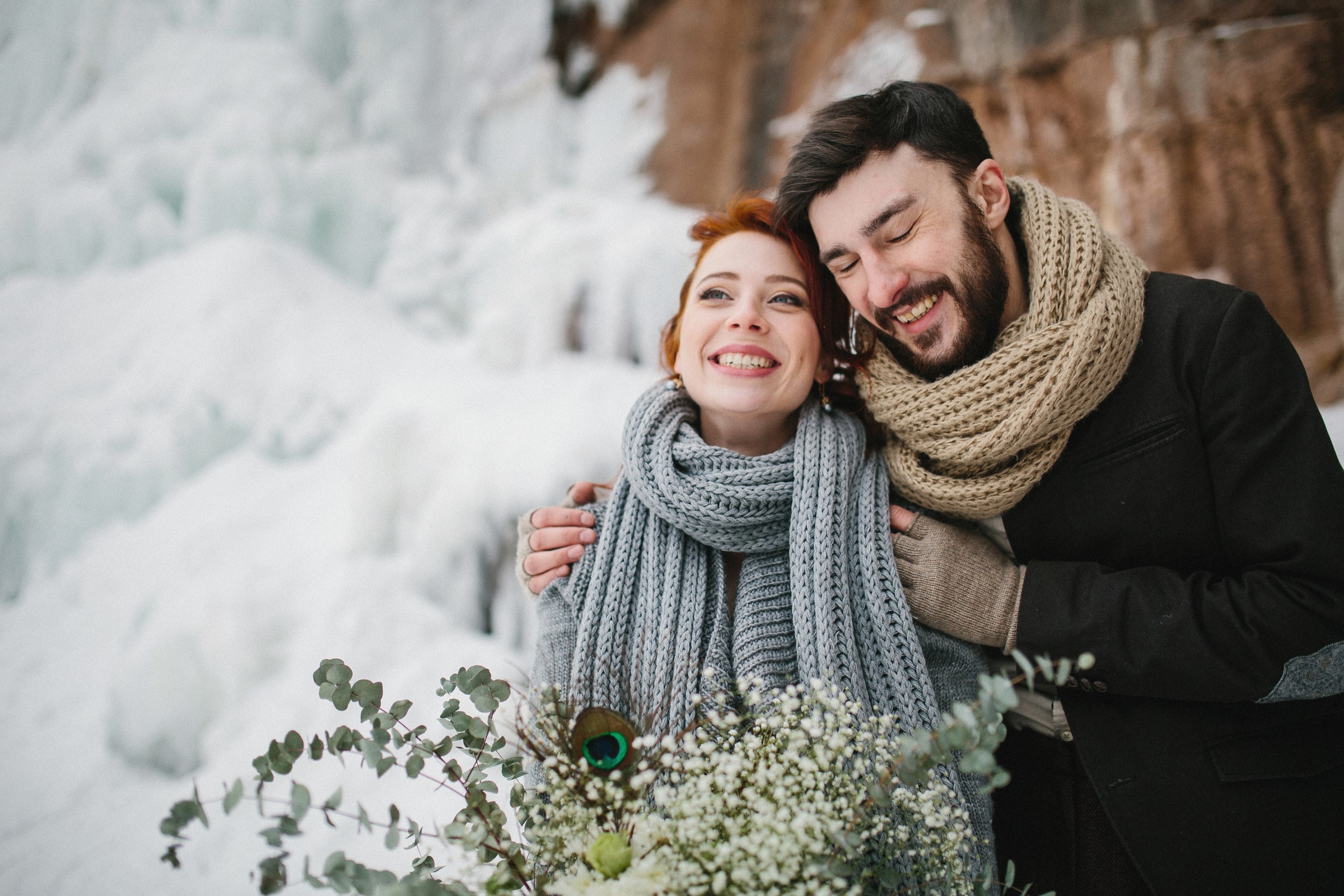 Couple hugging in winter with frozen waterfall HD Wallpaper