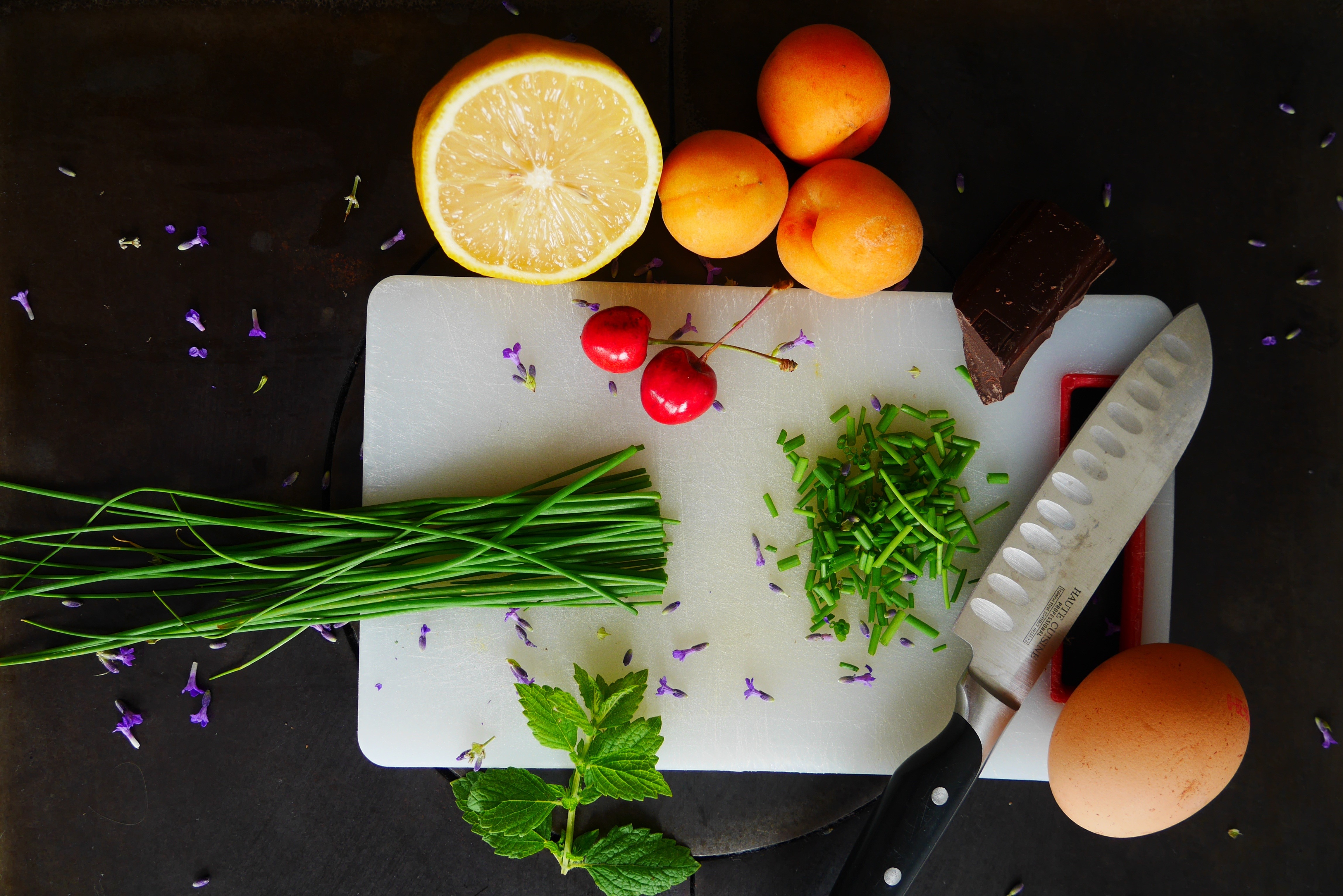 Ingredients for cooking: knife, egg, lemon, apricots, cherries, chives, chocolate, mint HD Wallpaper