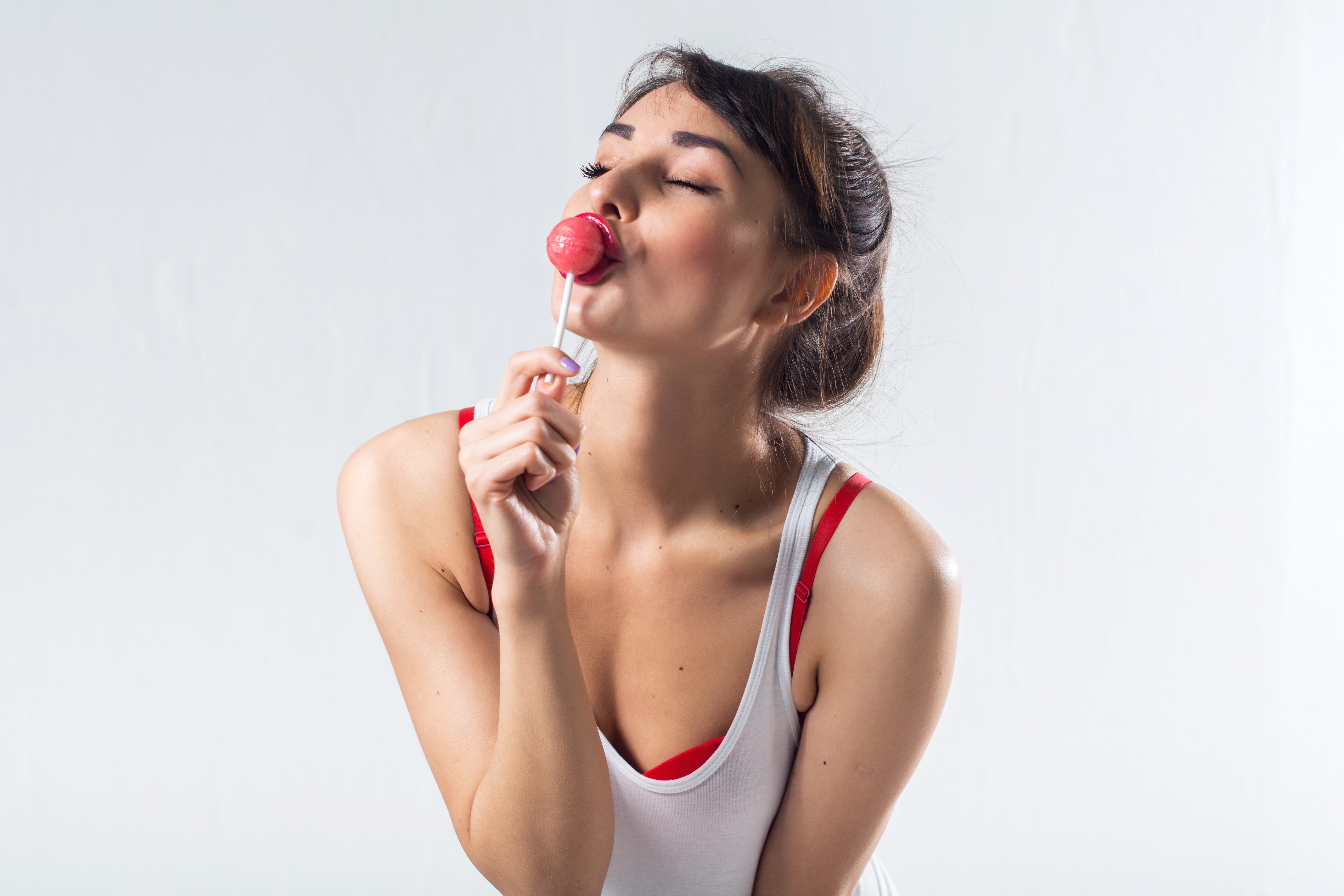 Woman with lollipop on gray background HD Wallpaper