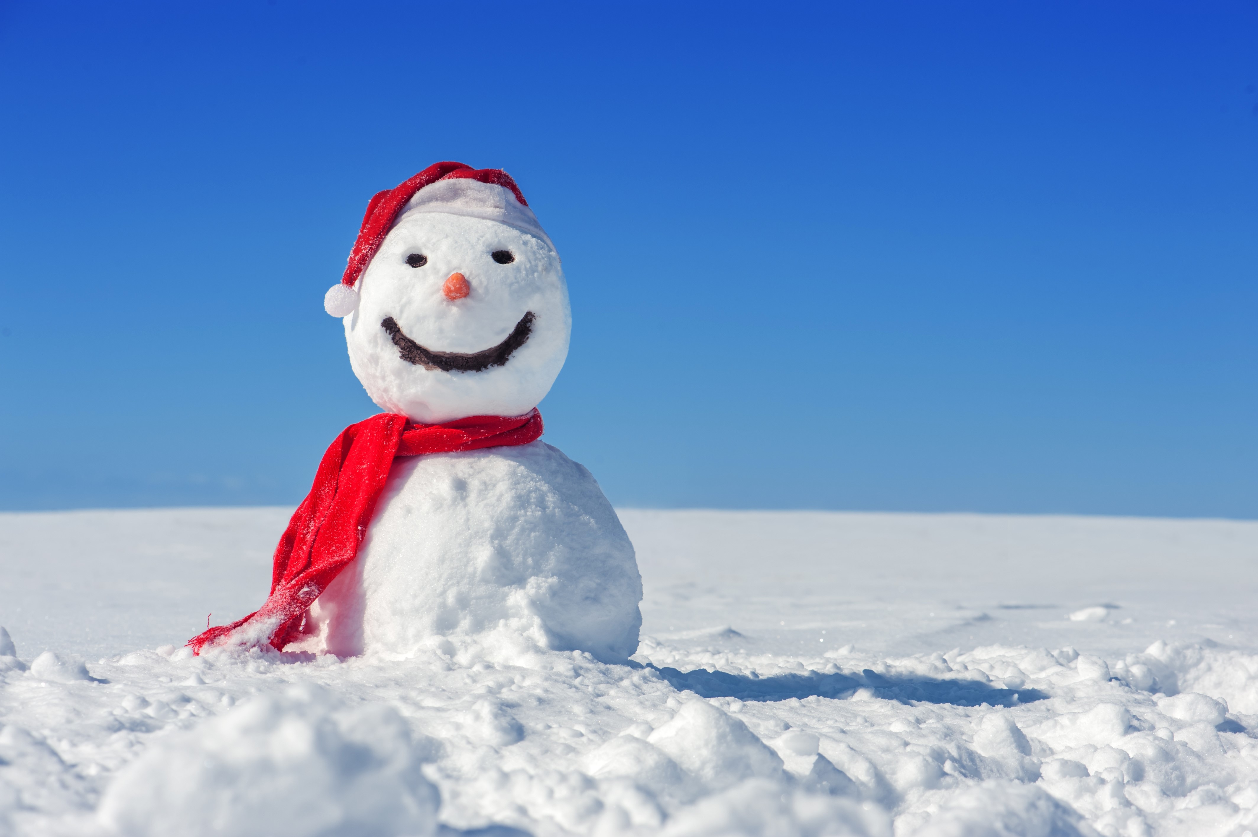 Snowman with Santa hat and scarf in snow HD Wallpaper