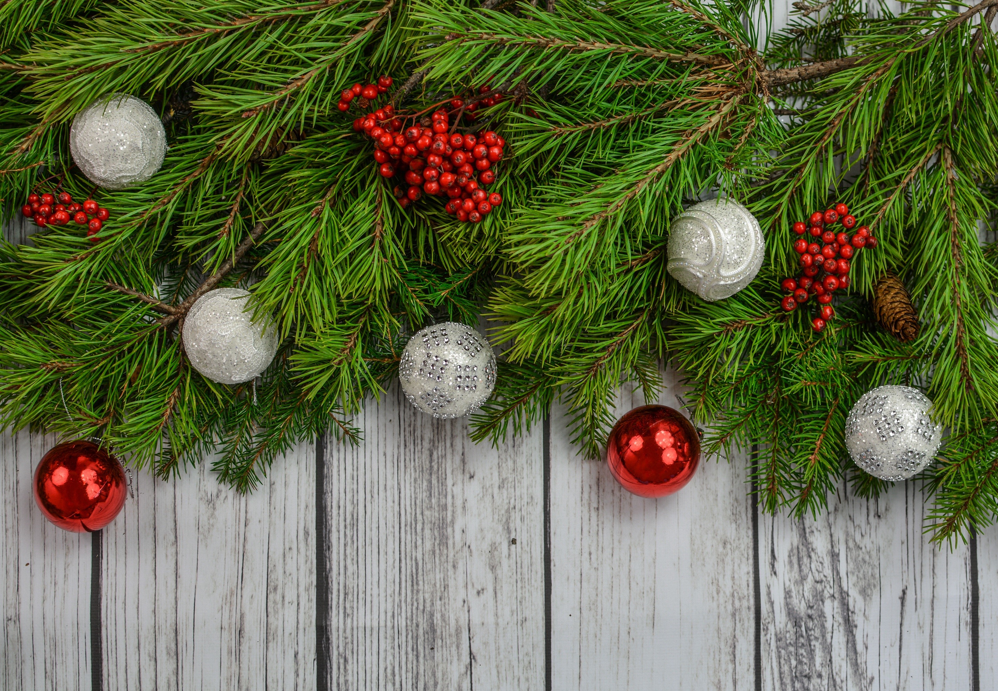 Christmas fir branches with ornaments and berries on wood HD Wallpaper