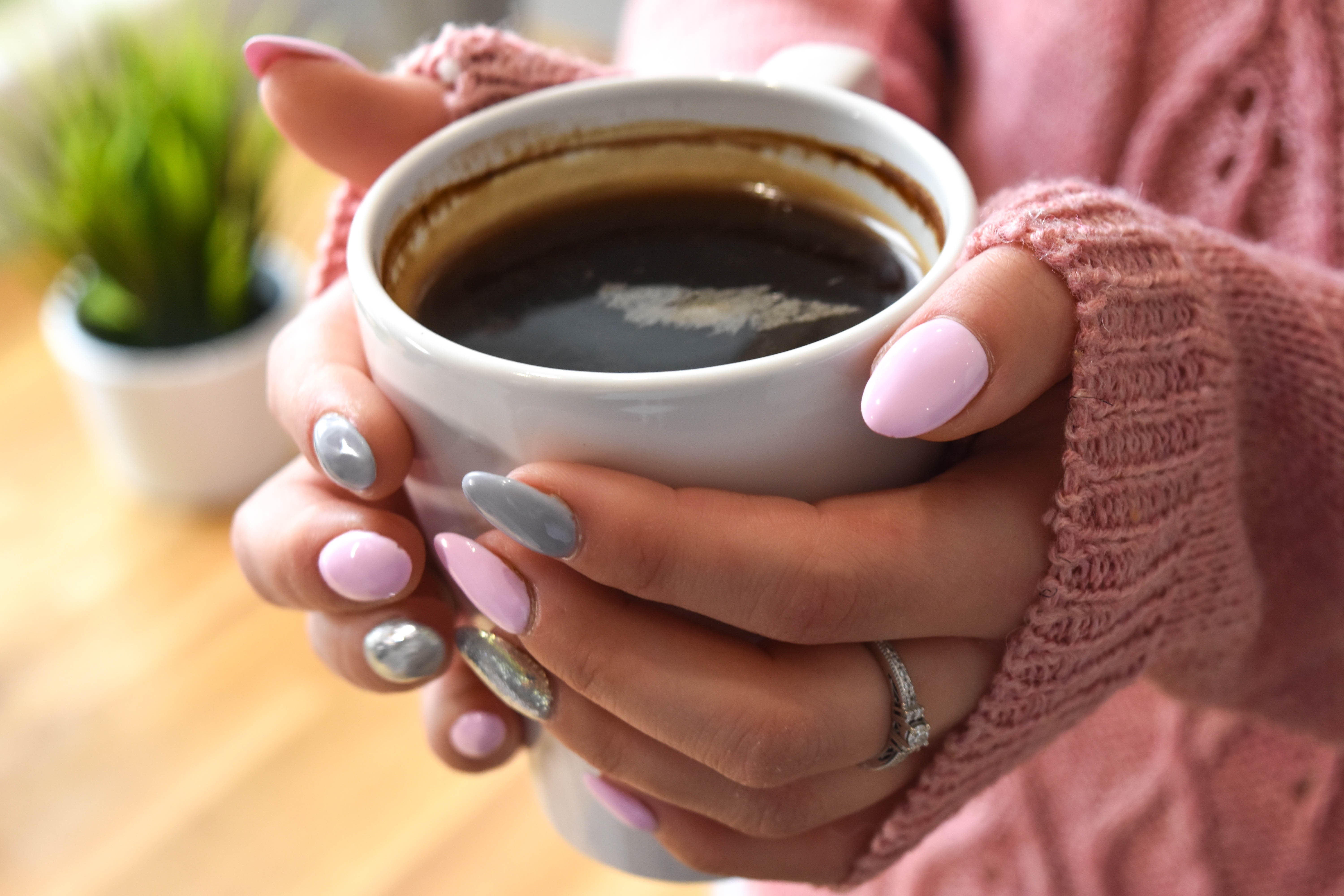 Hands holding a mug of coffee with manicure HD Wallpaper