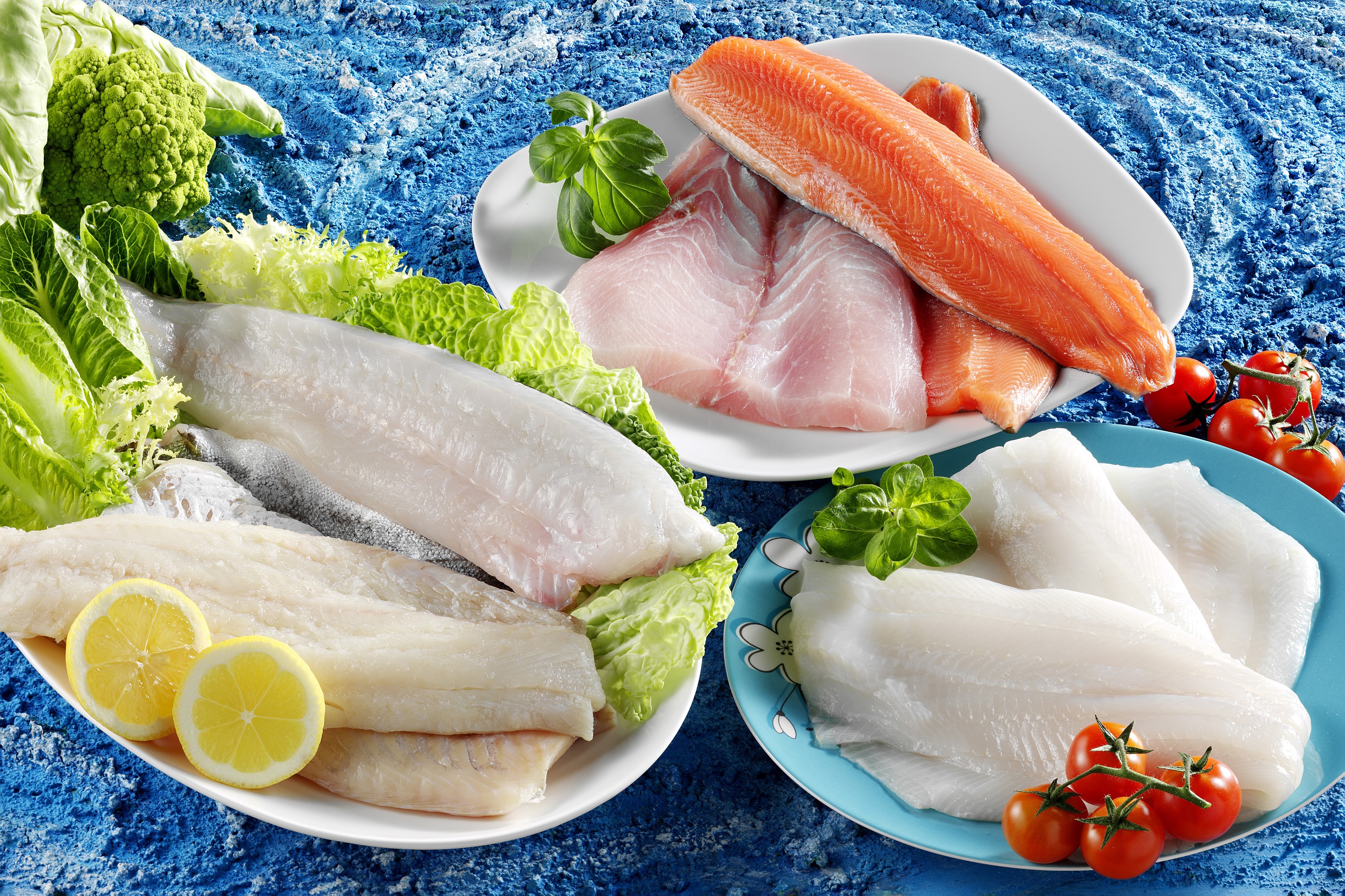 Assortment of fresh fish fillets with vegetables and lemons HD Wallpaper