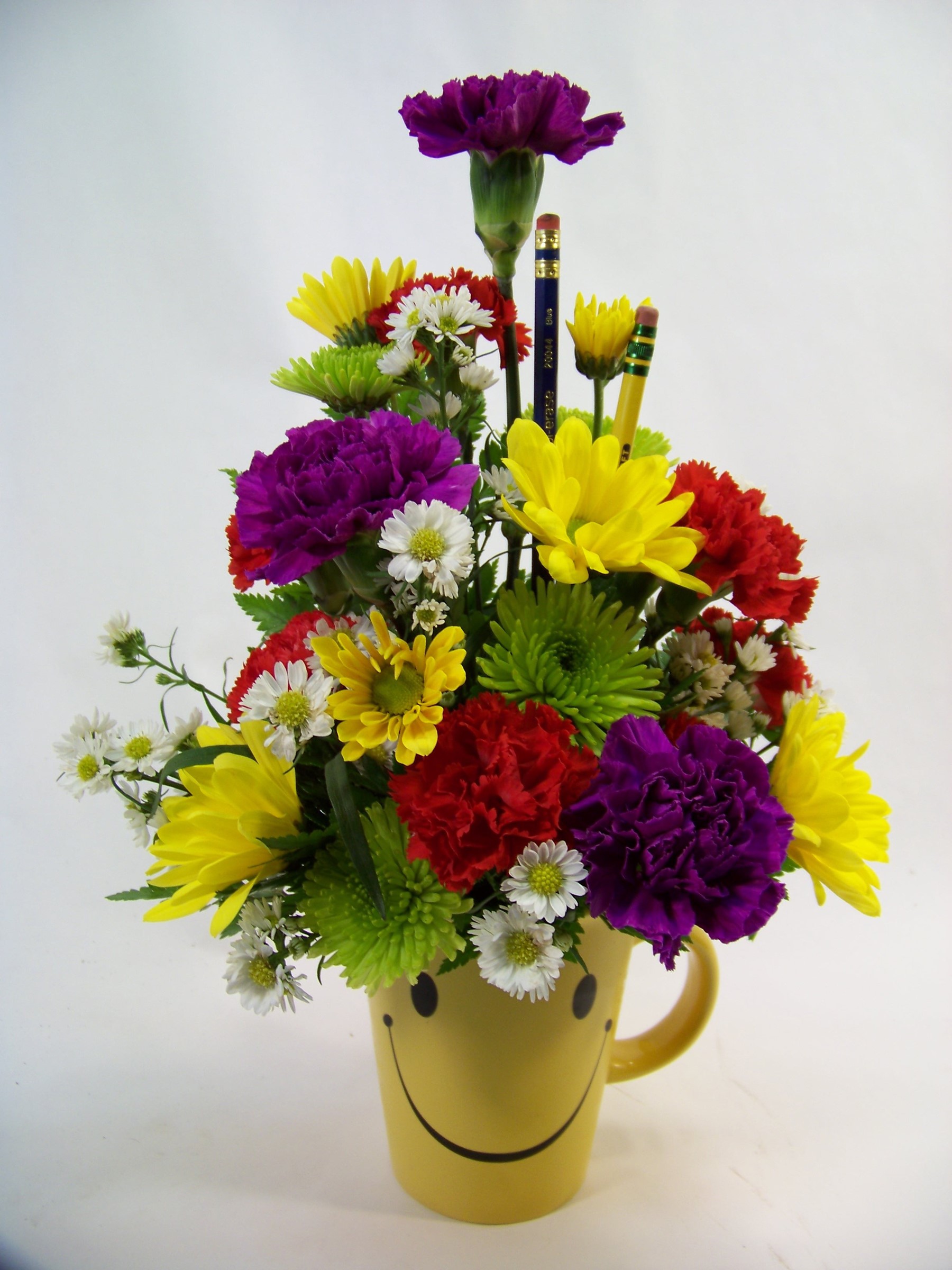 Flower arrangement in a smiley face mug with pencils HD Phone Wallpaper