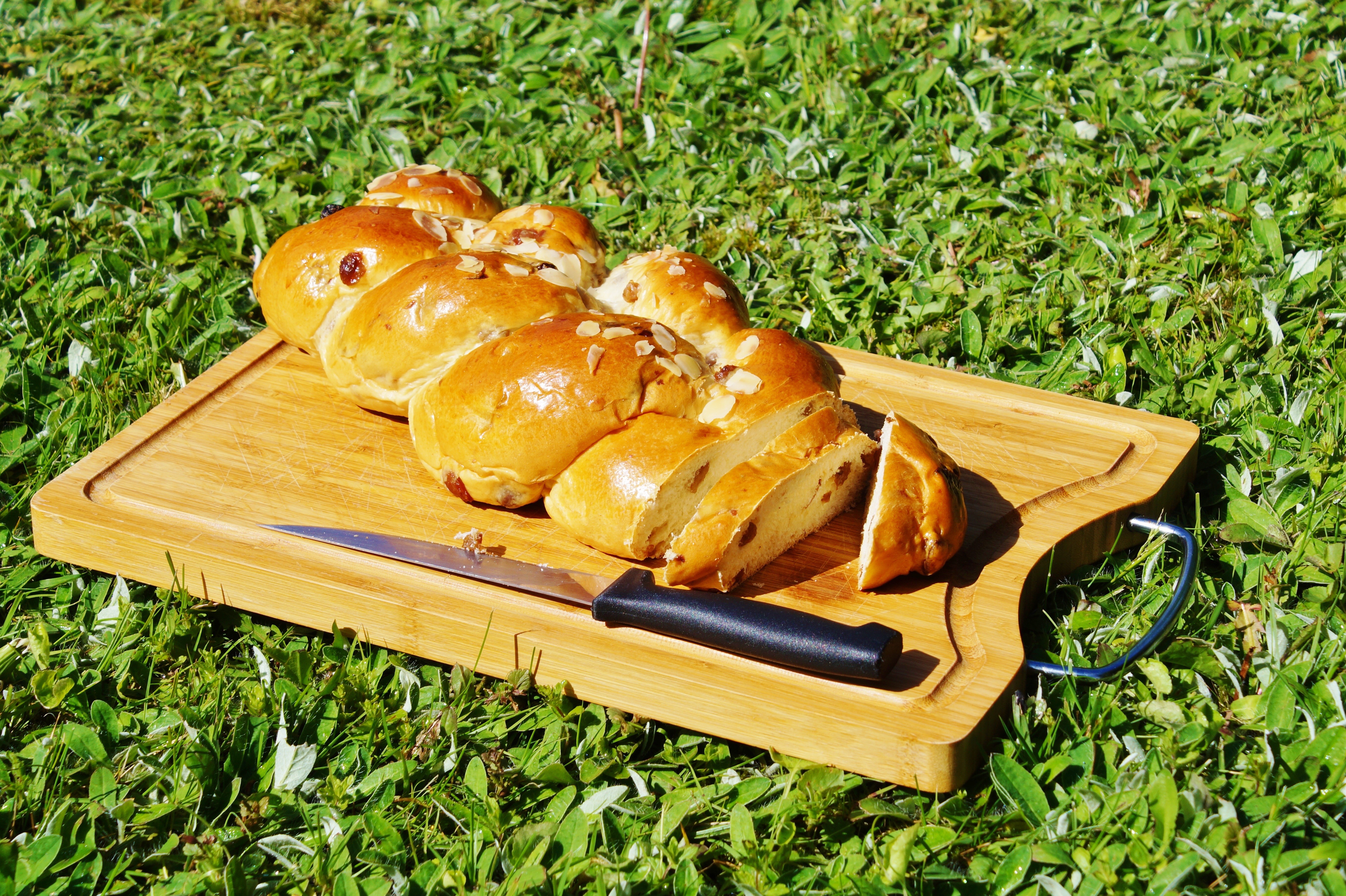 Sliced pastry with almonds and raisins on a cutting board HD Wallpaper