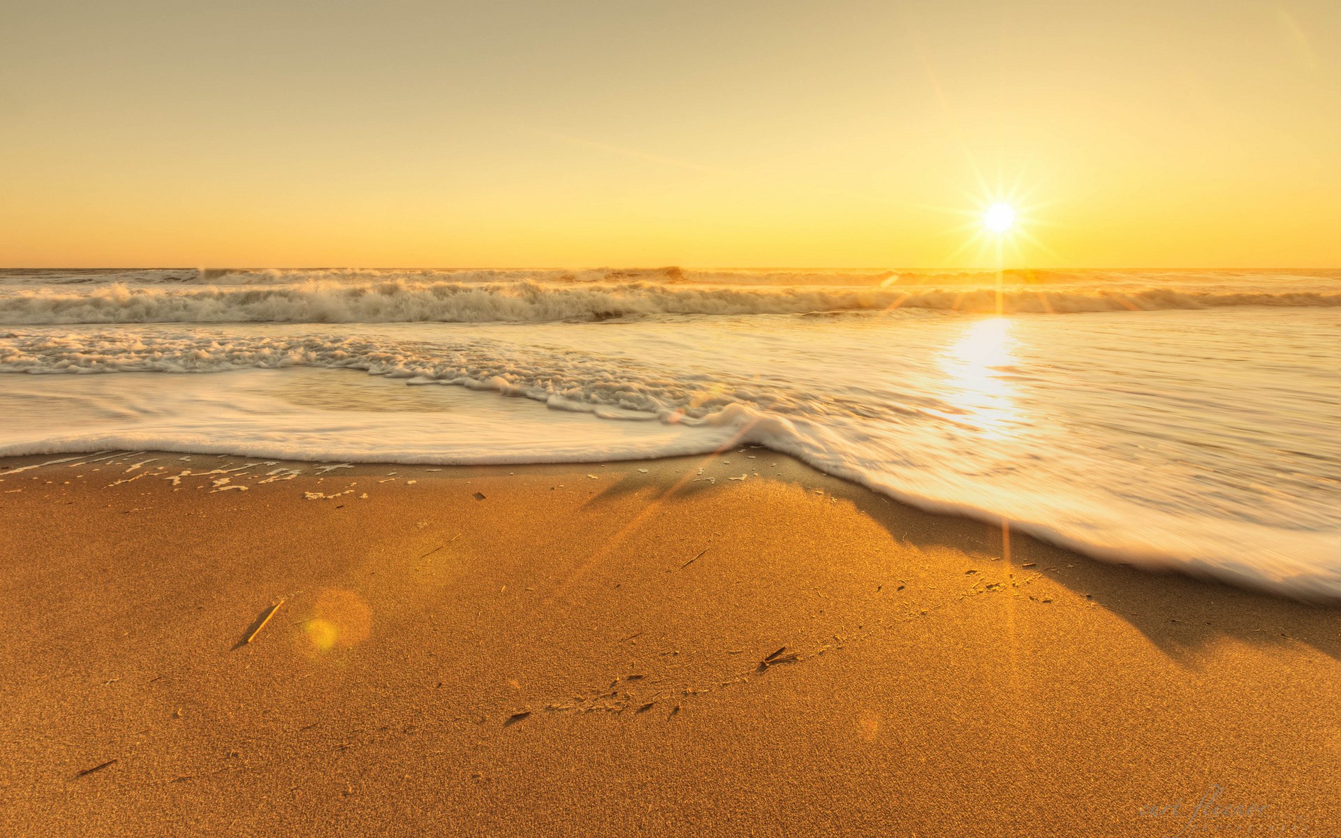 Sunset over the ocean with waves on the beach HD Wallpaper