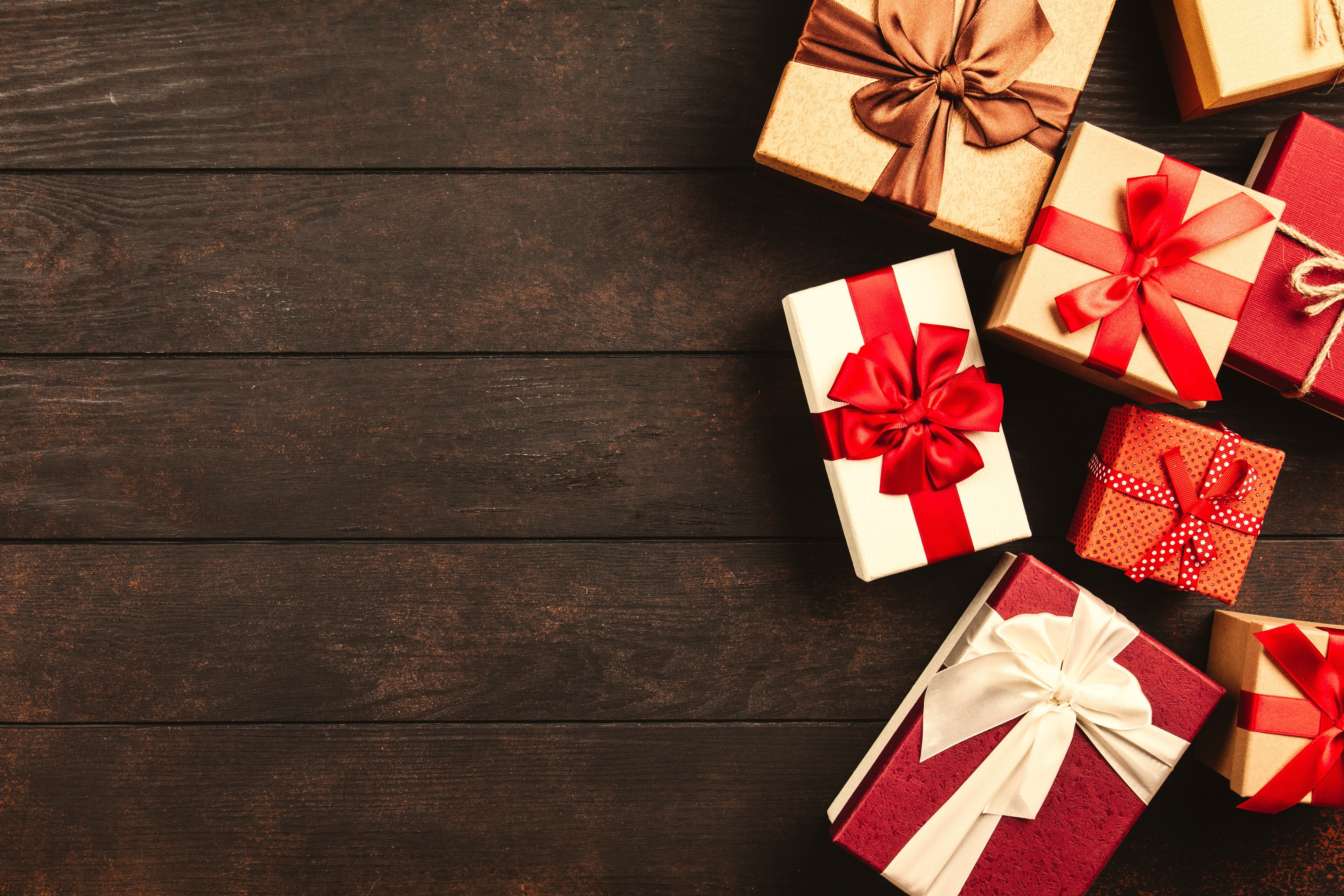 Christmas gifts with bows on wooden planks HD Wallpaper