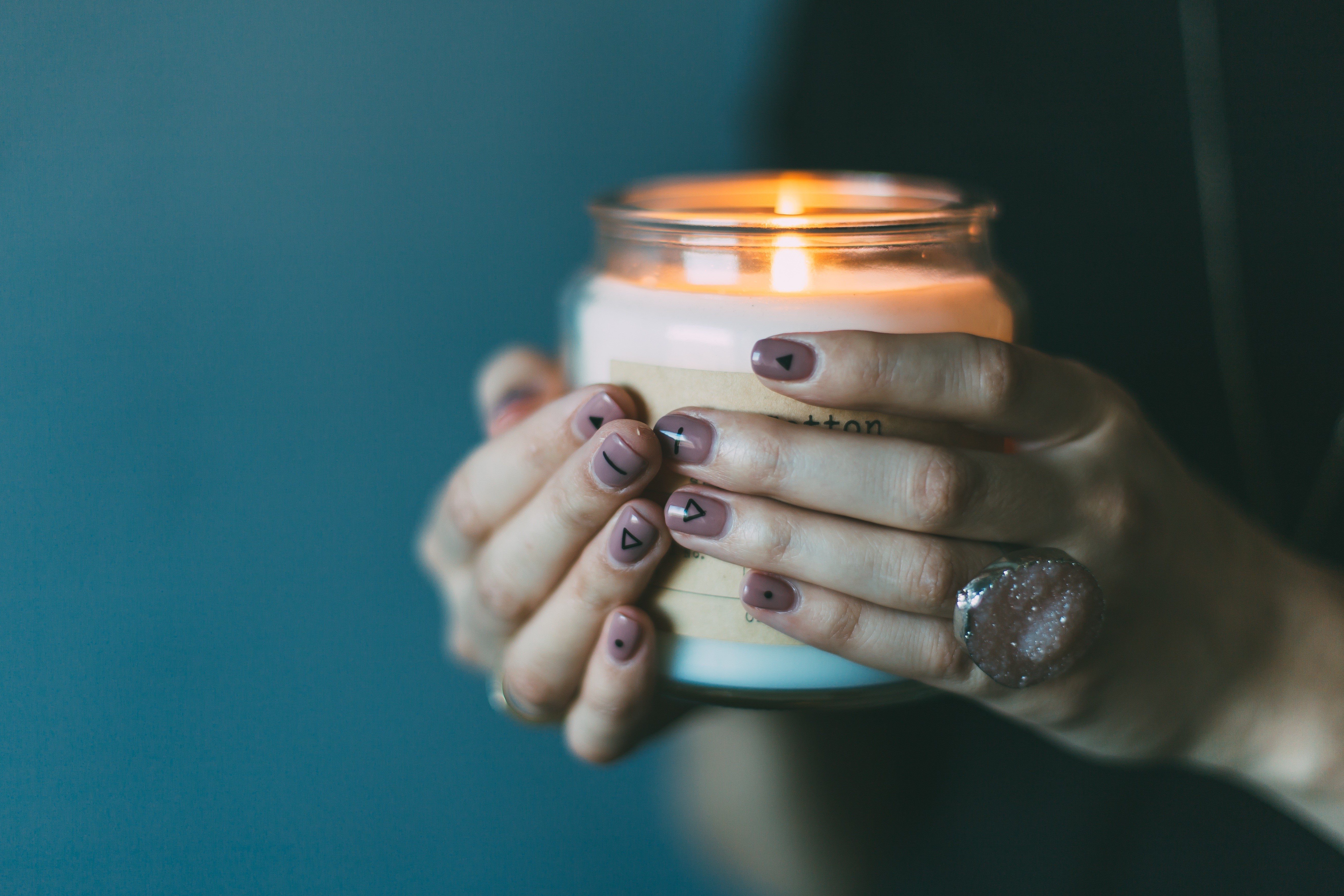 Hands holding a lit candle HD Wallpaper
