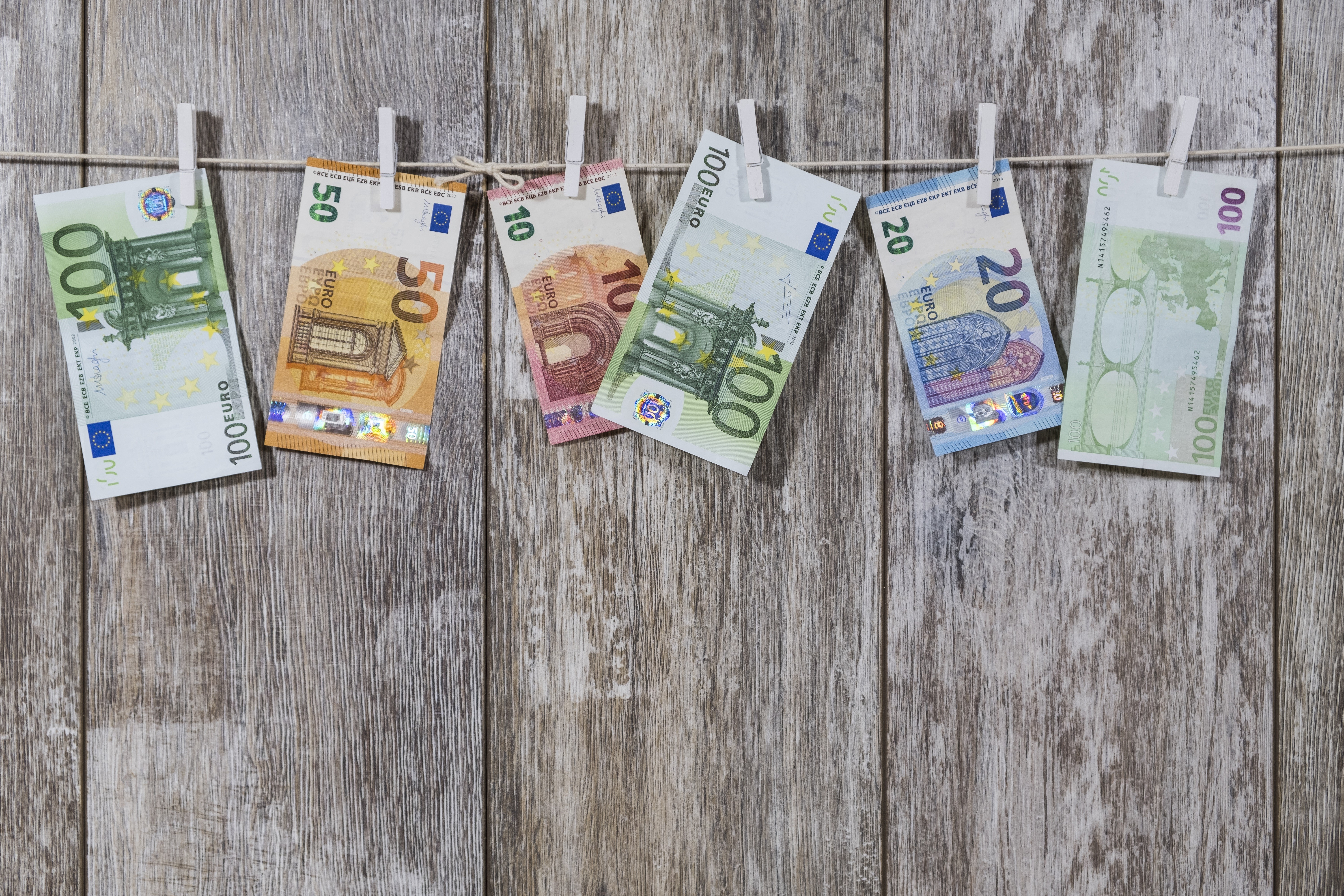 Euro banknotes drying on a clothesline HD Wallpaper