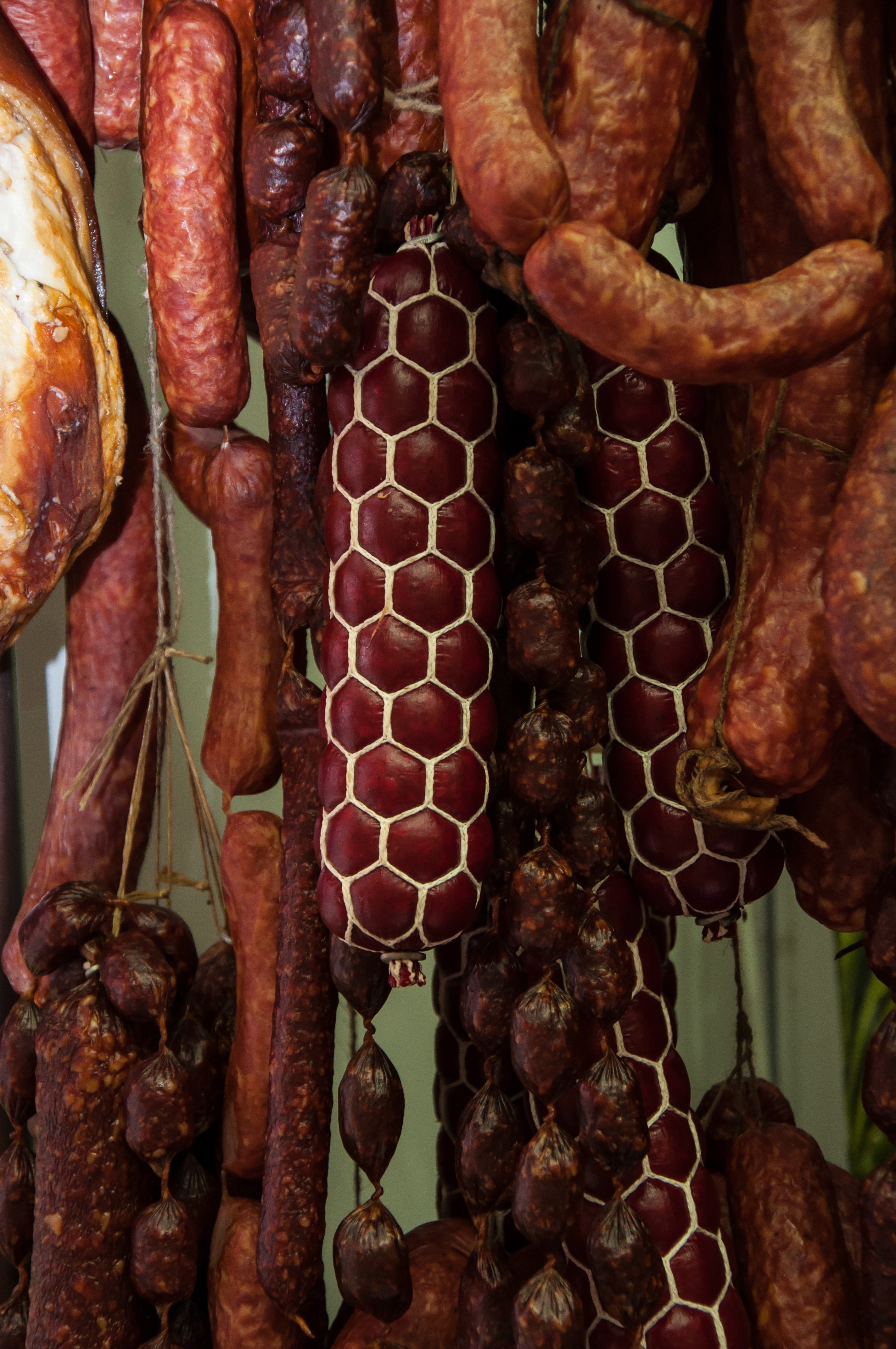 Hanging cured meat products and sausages HD Phone Wallpaper