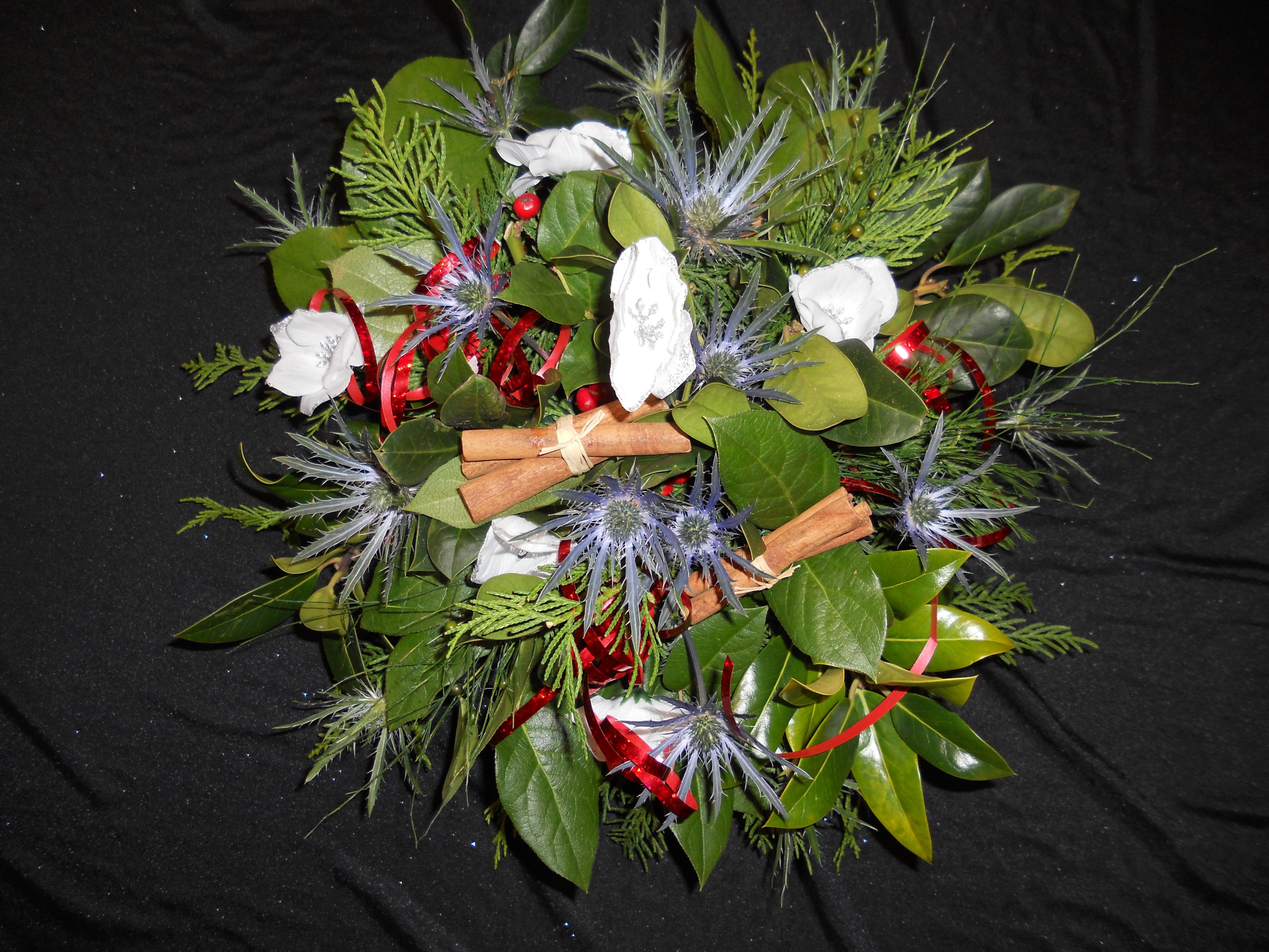 Christmas bouquet with anemones, foliage, and cinnamon sticks HD Wallpaper
