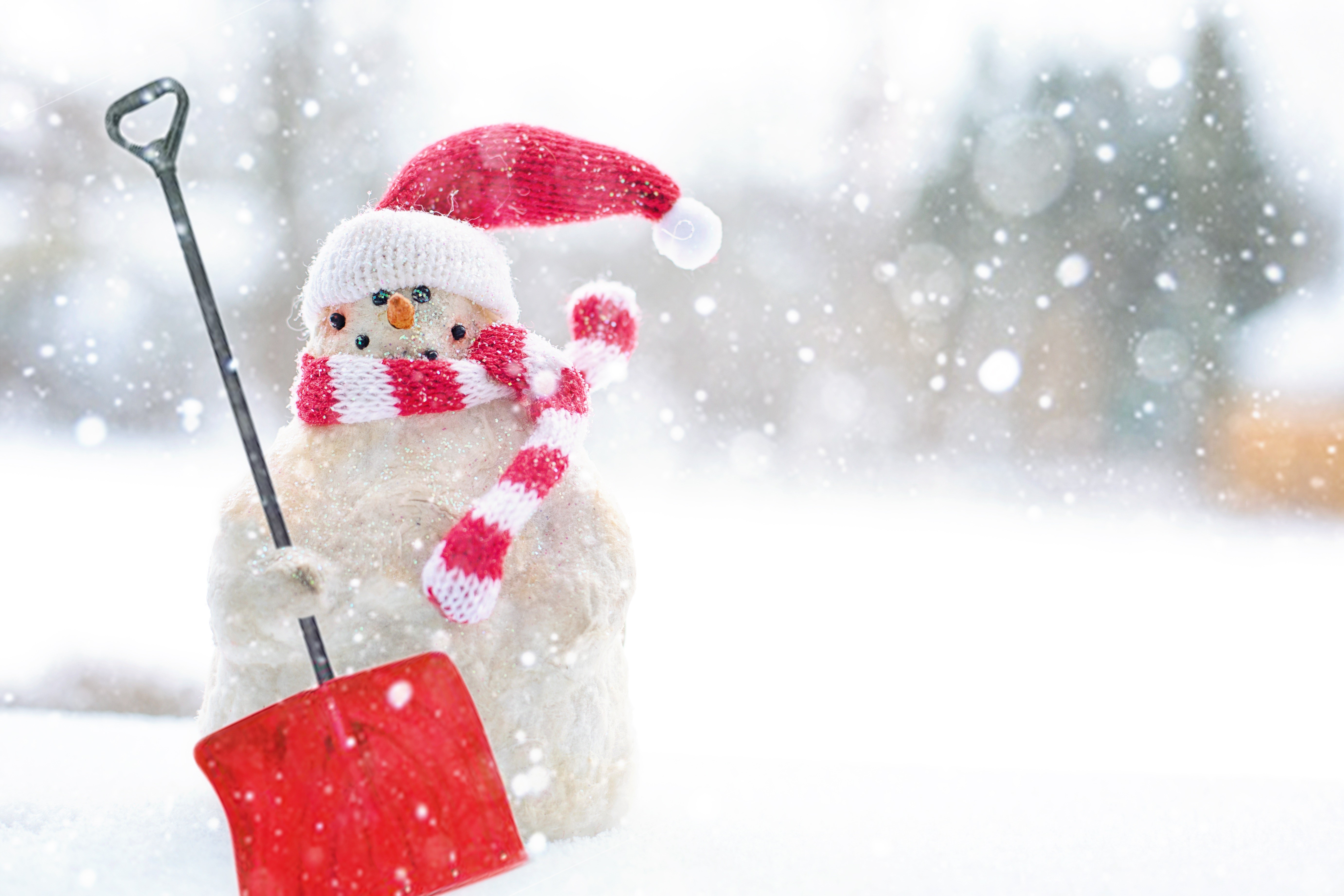 Snowman with shovel and red hat in snow HD Wallpaper