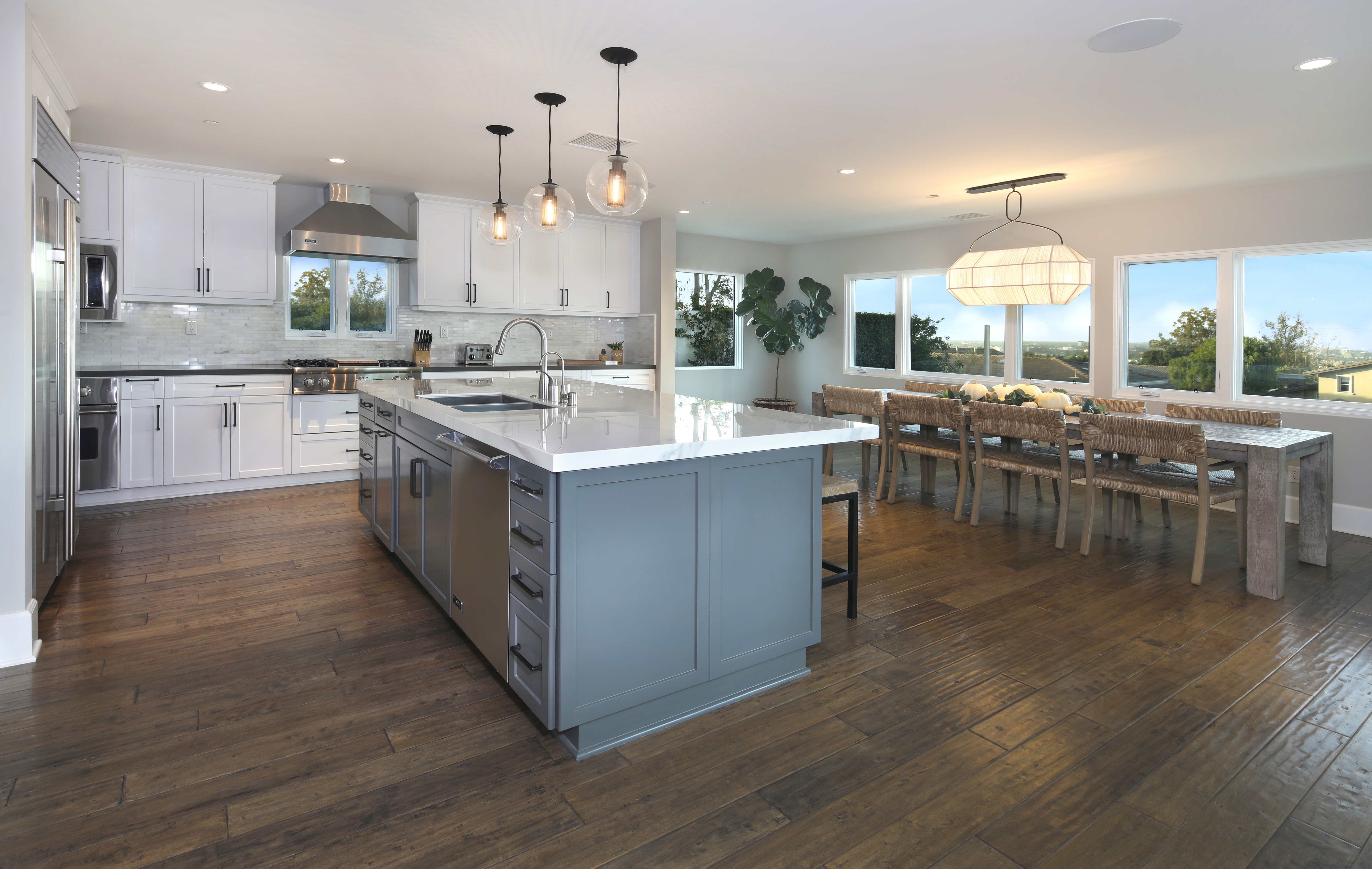 Modern Kitchen and Dining Area with Island and Large Windows HD Wallpaper