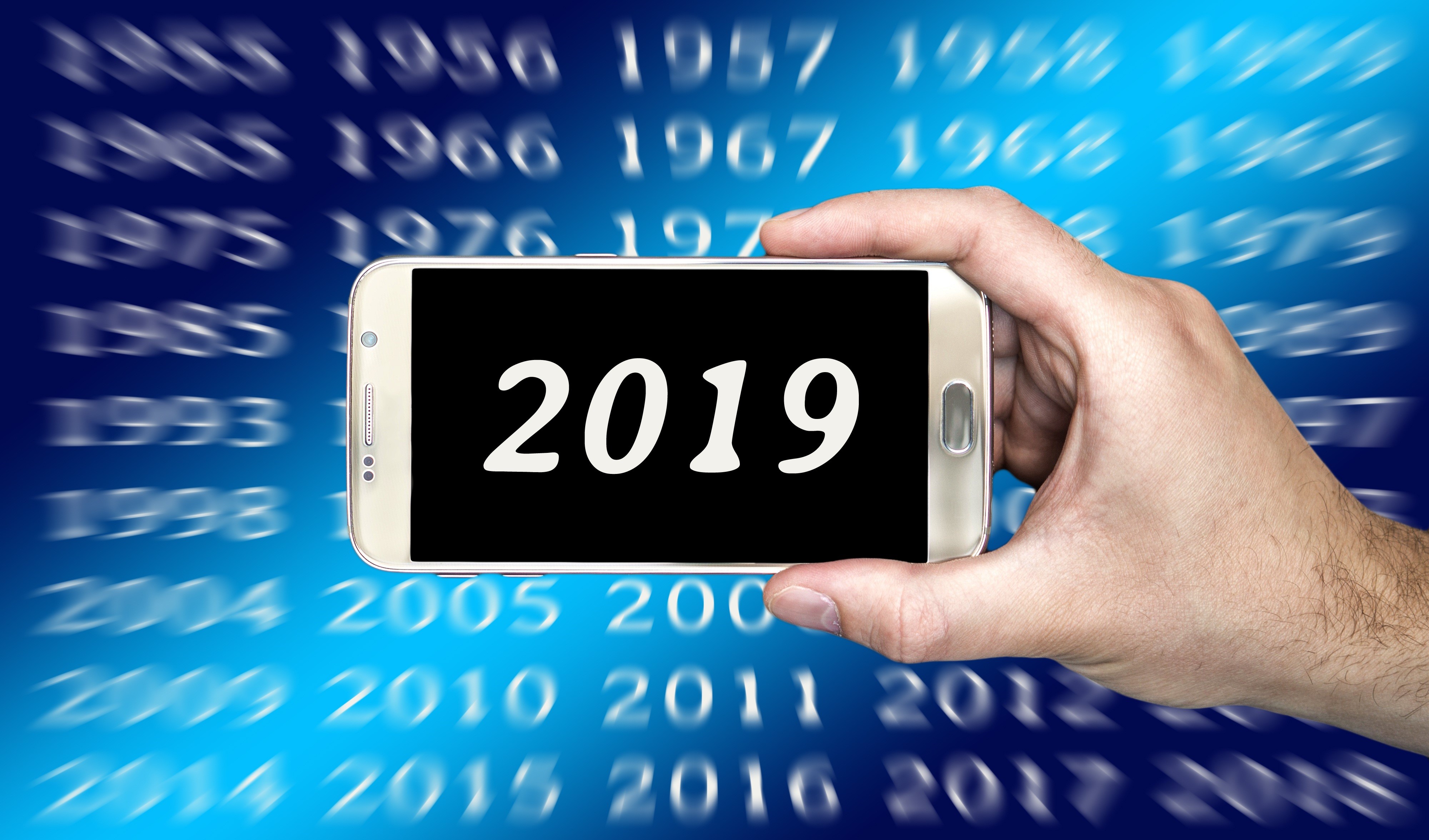 Smartphone displaying 2019 with years in background HD Wallpaper