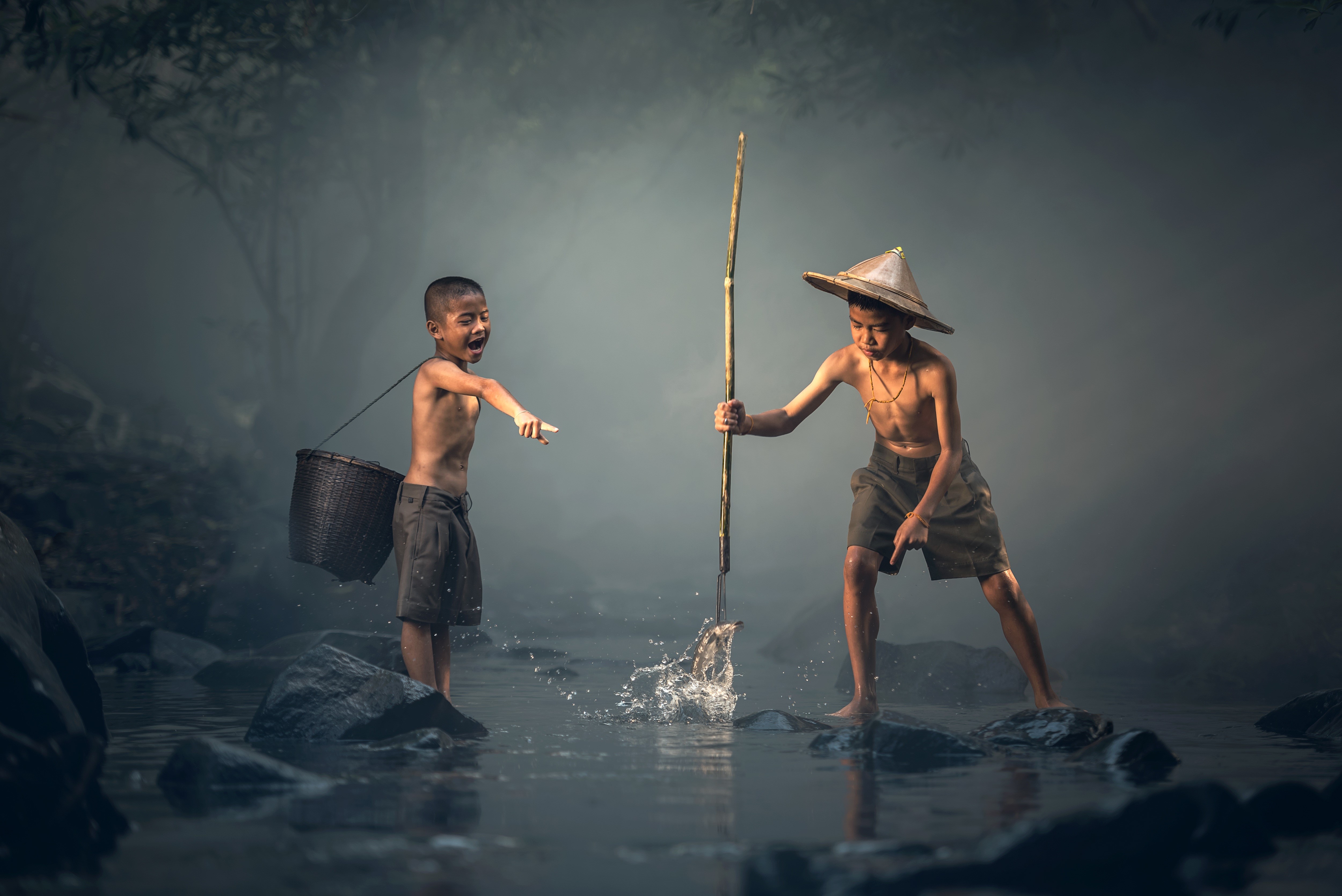 Two Asian boys fishing in a stream HD Wallpaper