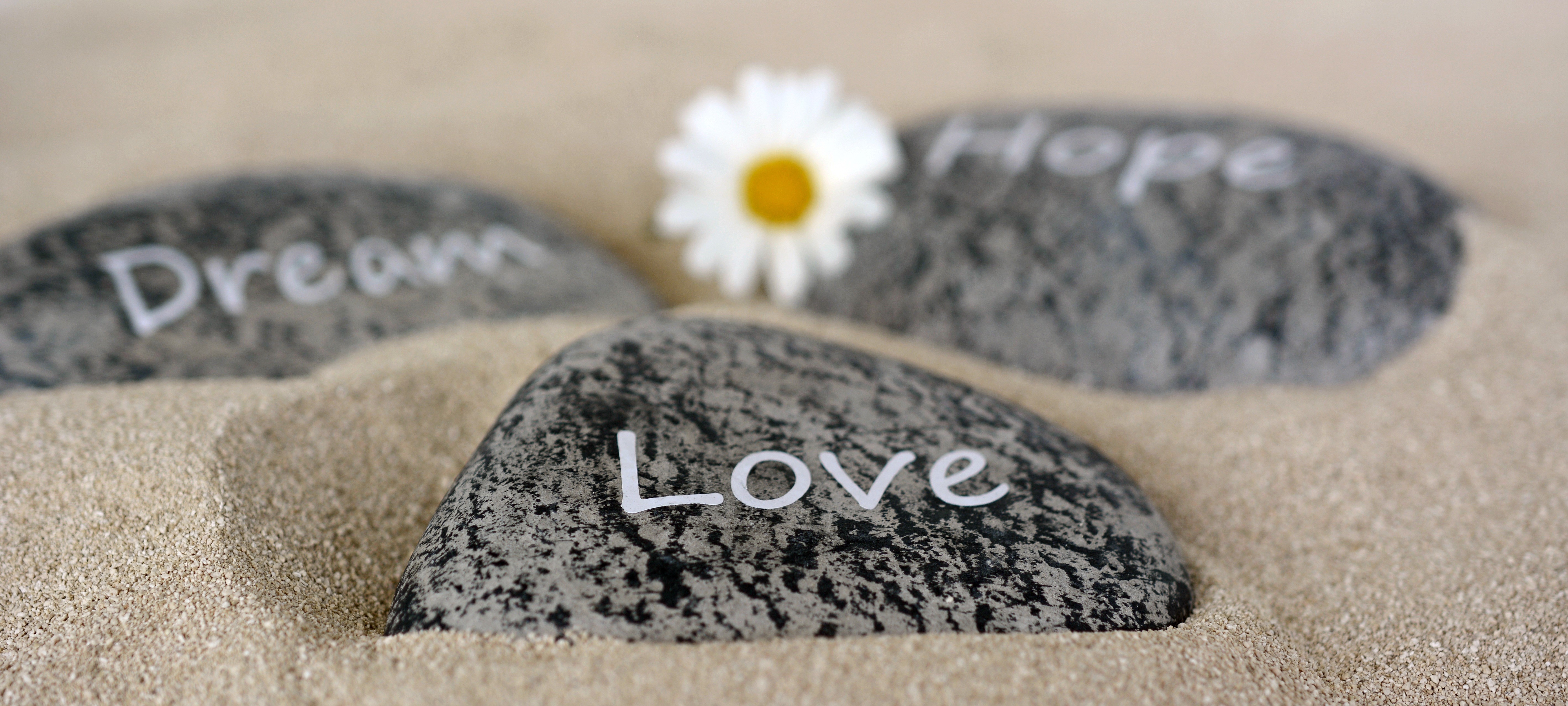 Stones with words Love, Dream, Hope on sand HD Wallpaper