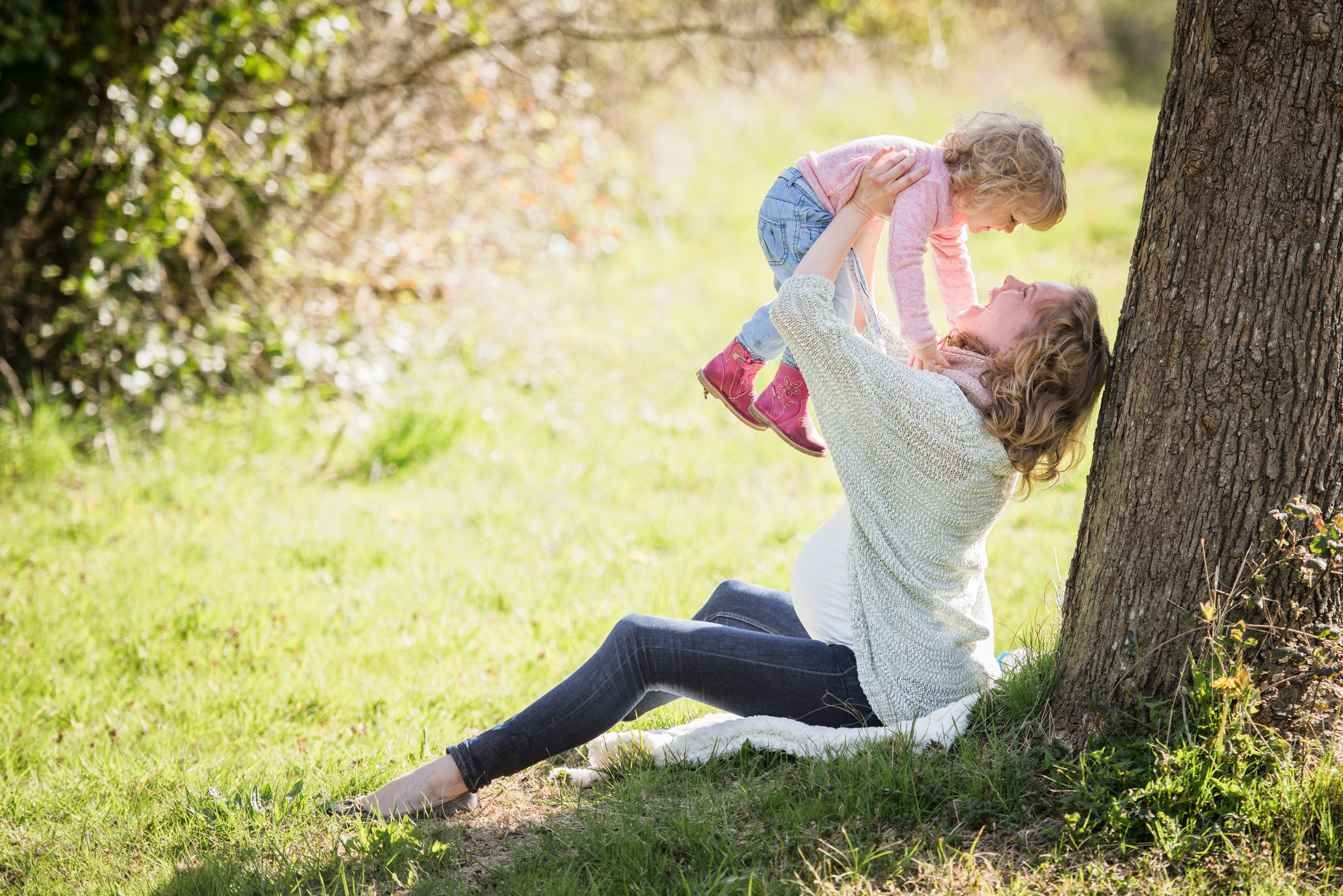 Pregnant Woman Holding Daughter by Tree HD Wallpaper