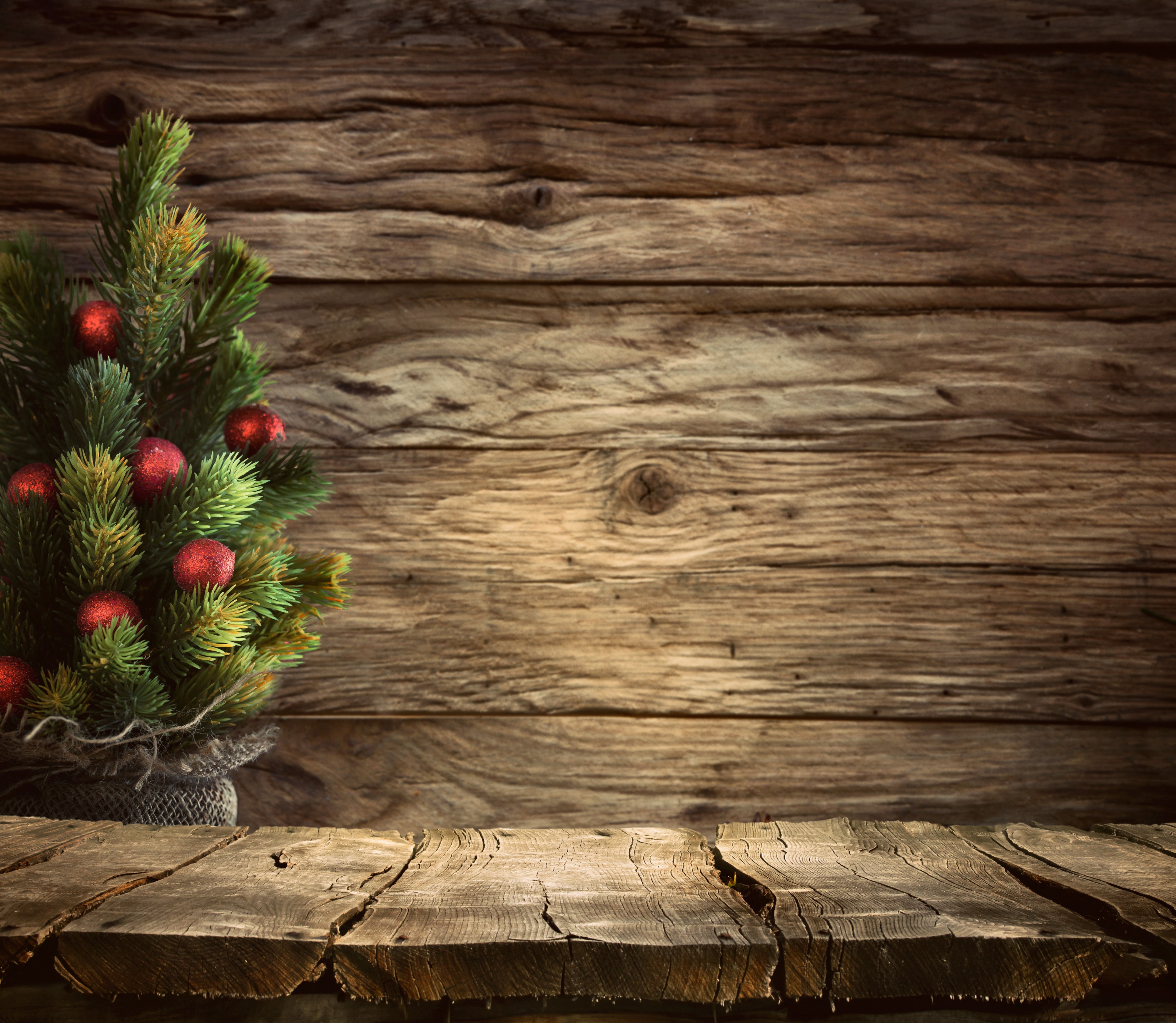 Christmas tree with red ornaments on wooden background HD Wallpaper