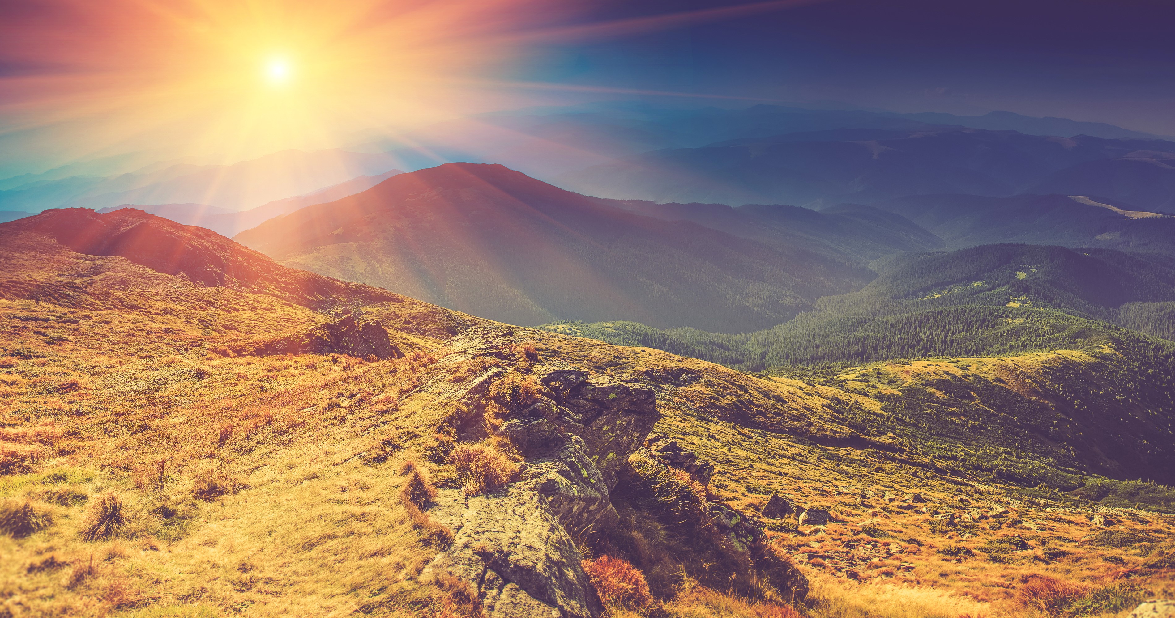 Sunlight over mountains and grassy hills HD Wallpaper