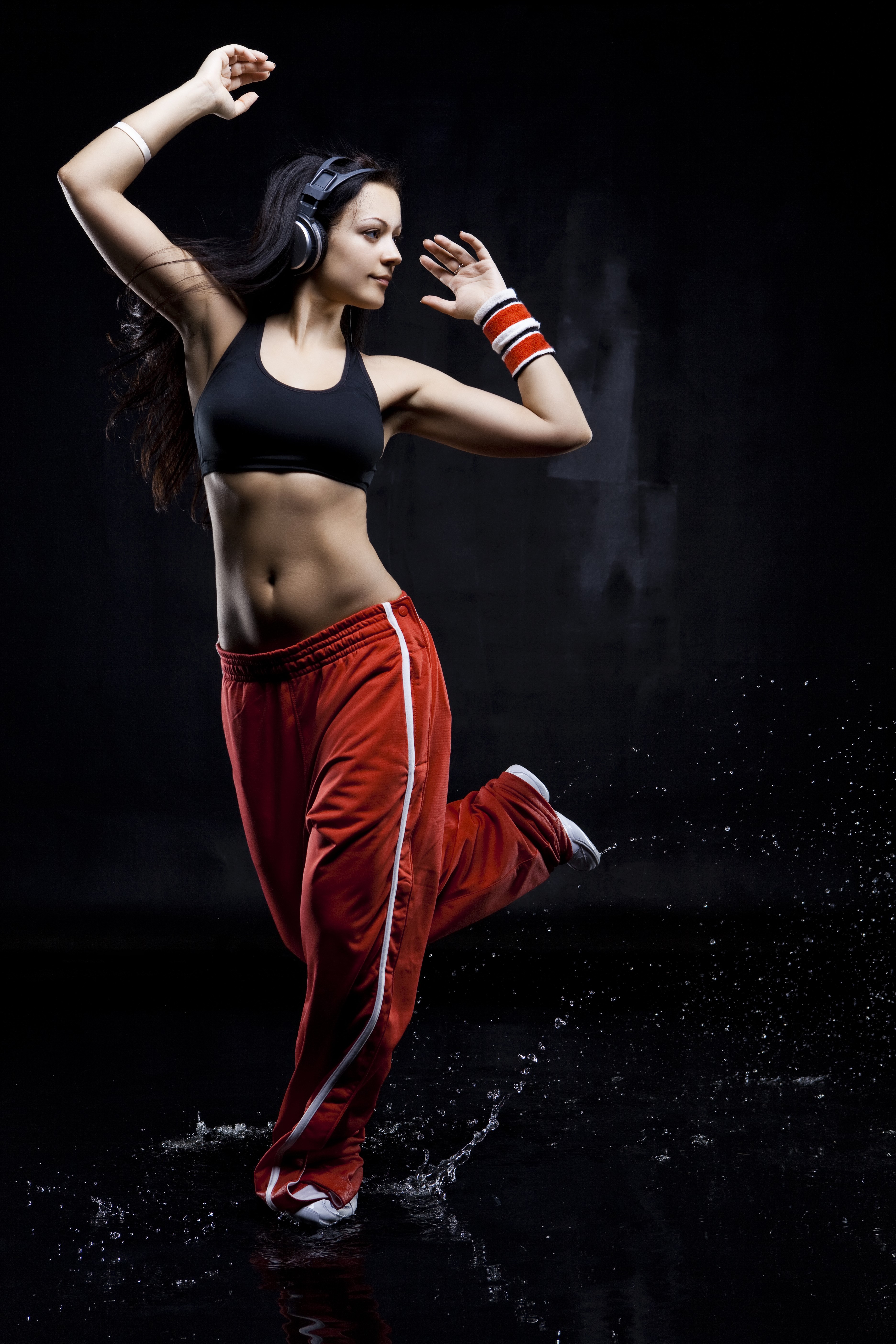 Woman with headphones dancing in red pants HD Phone Wallpaper