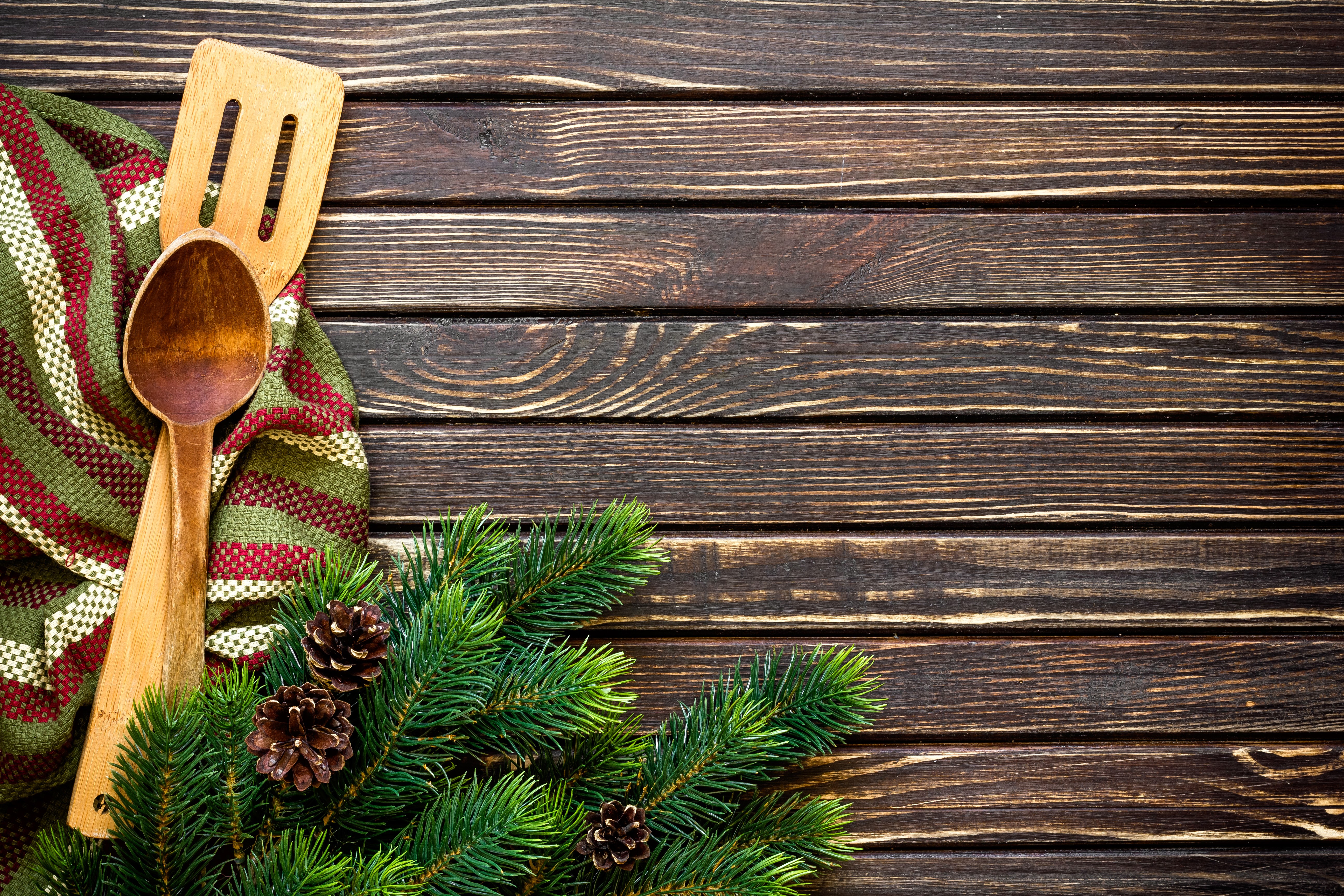 Christmas pine branches with wooden spoon and towel on wood planks HD Wallpaper