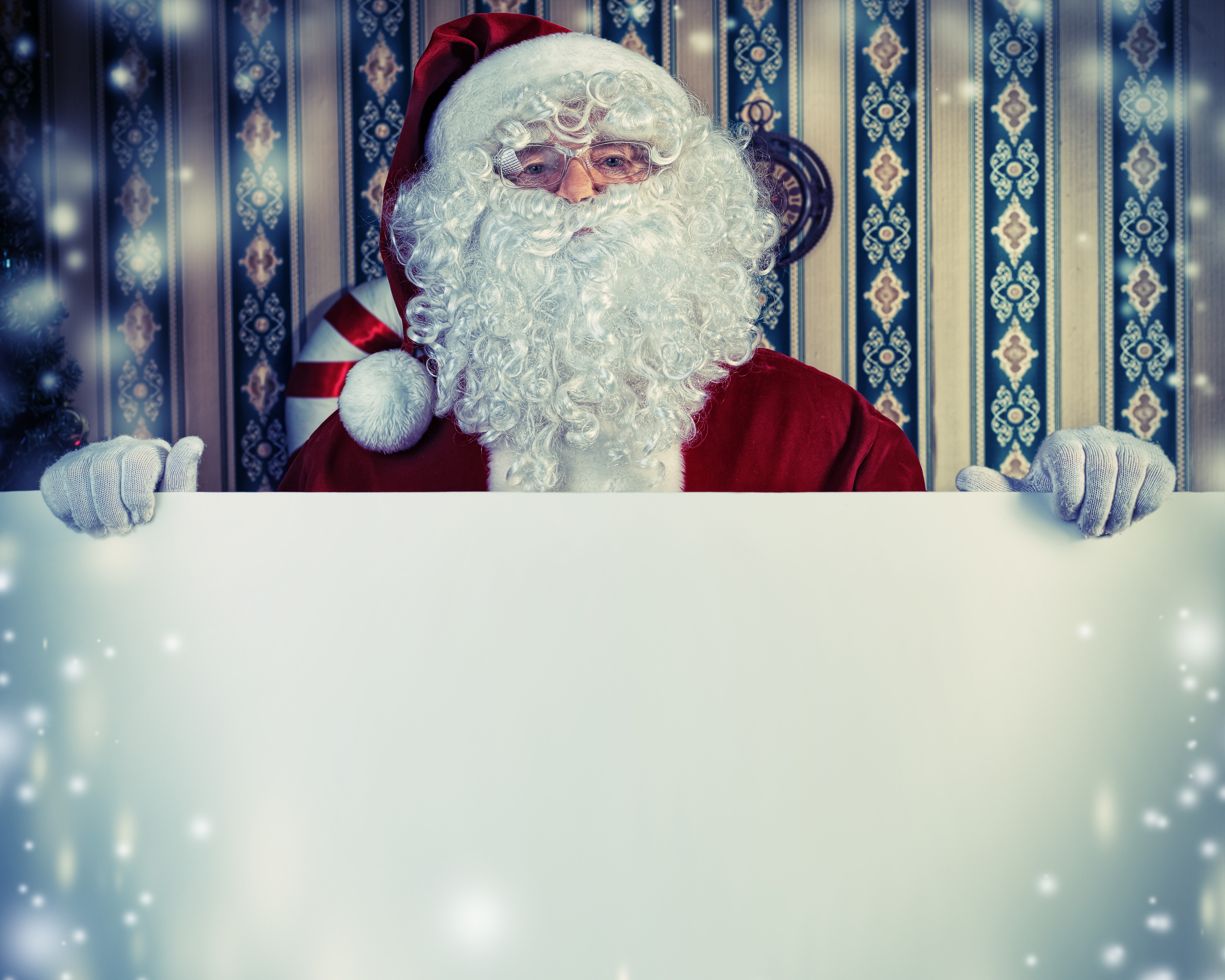Santa Claus holding a blank sign with snowflakes HD Wallpaper