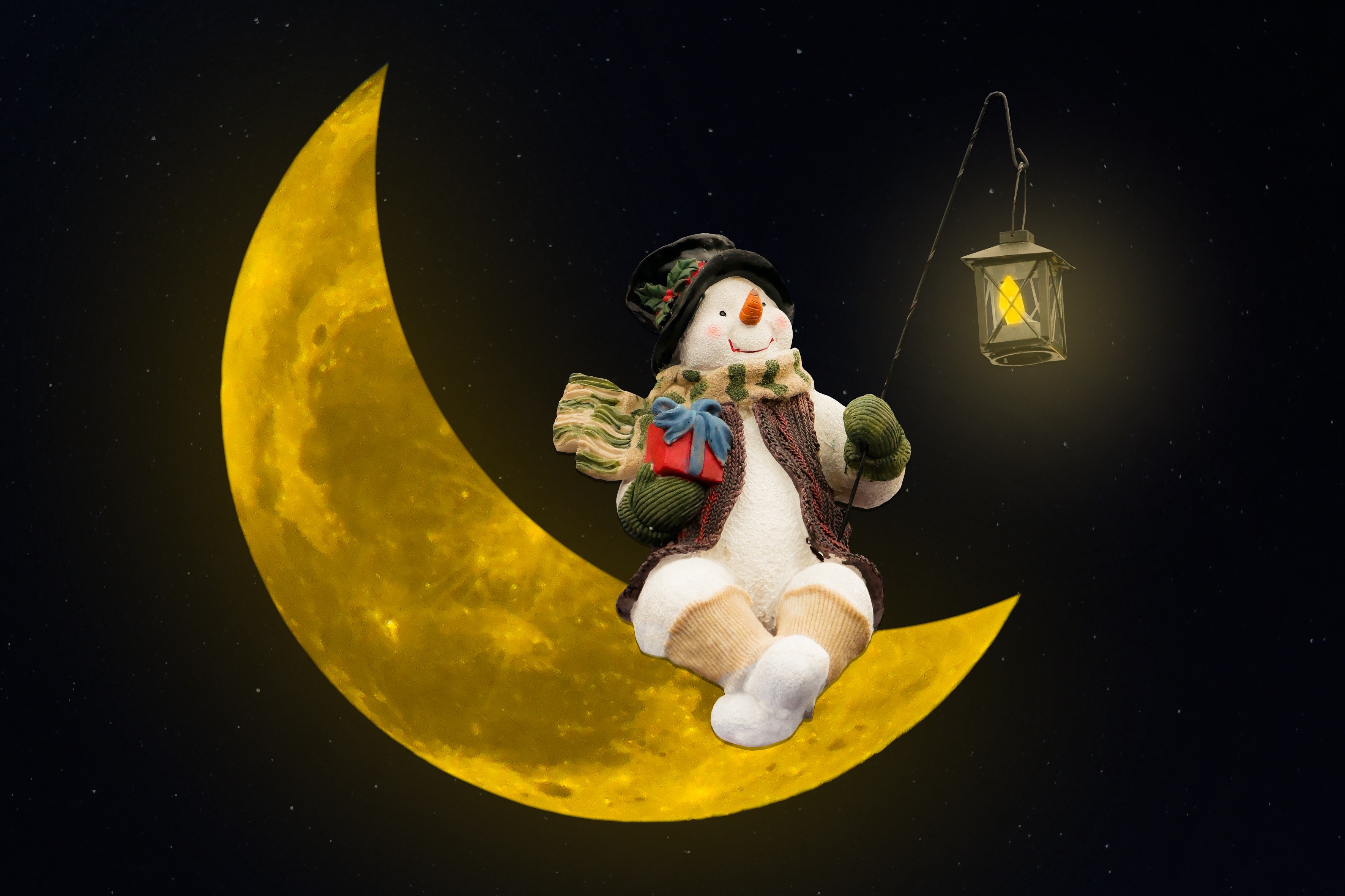 Snowman with gift and lantern on a crescent moon HD Wallpaper