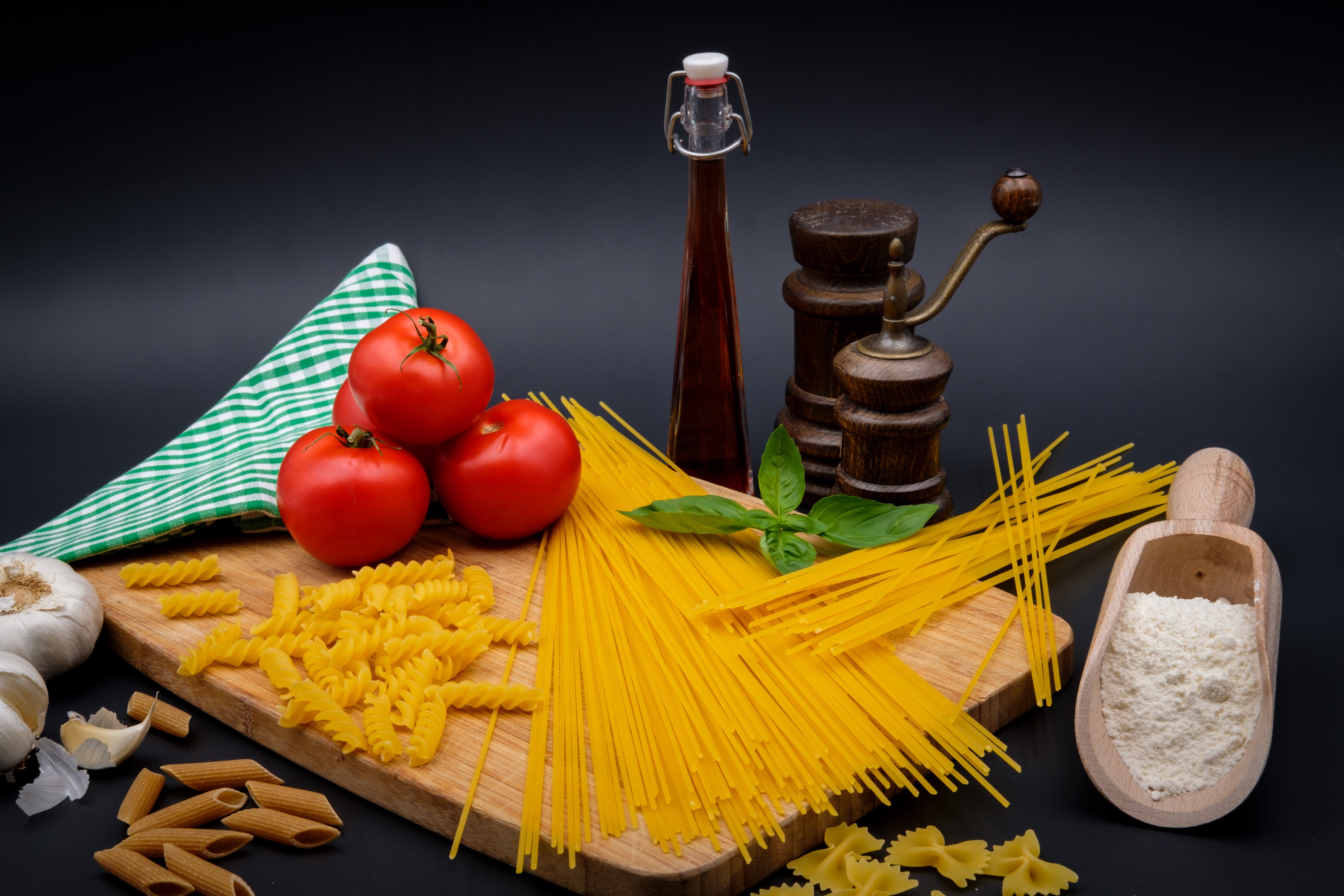 Tomatoes, Pasta, Flour, and Garlic on a Cutting Board HD Wallpaper