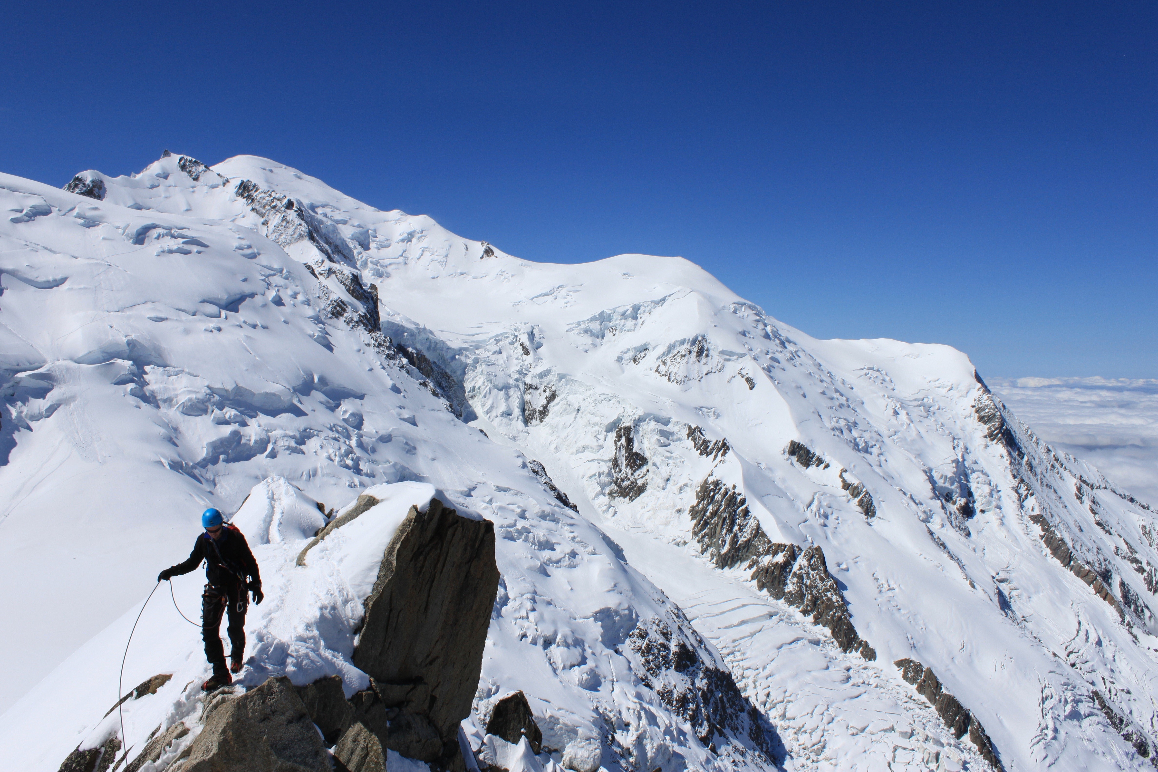 Mountaineer on a snowy mountain ridge HD Wallpaper