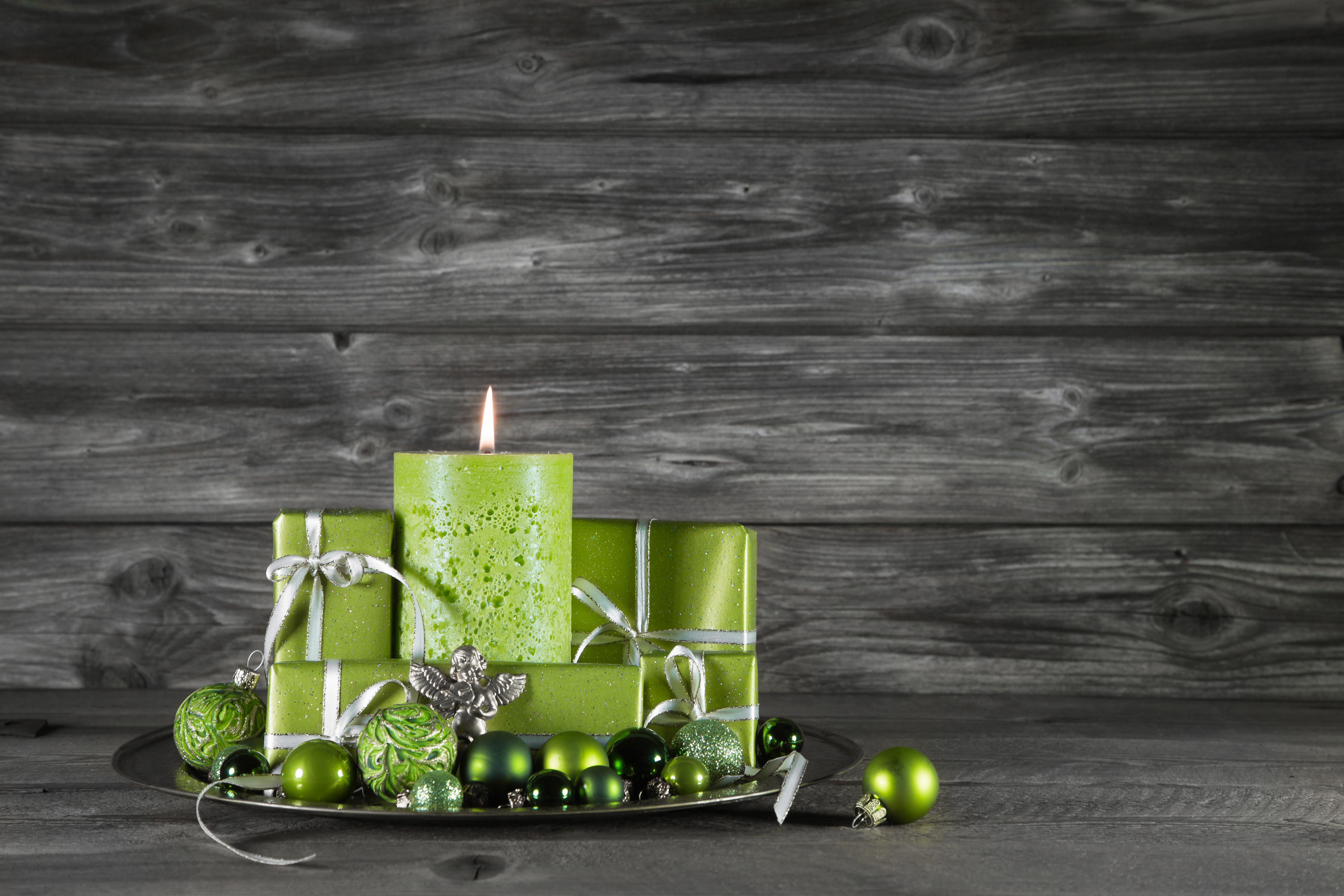Christmas candle with gifts and ornaments on wood planks HD Wallpaper