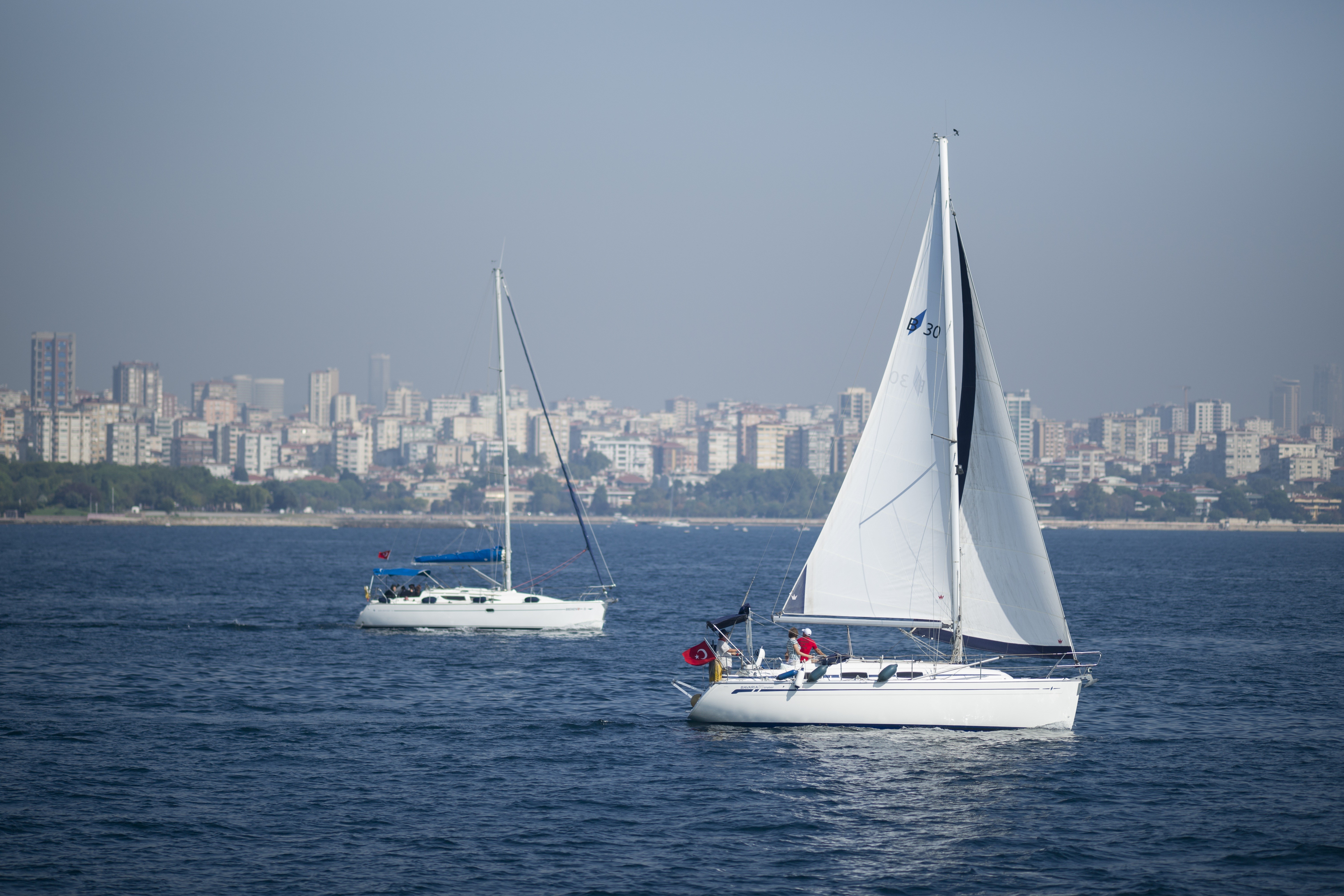 Two sailboats on the water with Istanbul skyline in the background HD Wallpaper