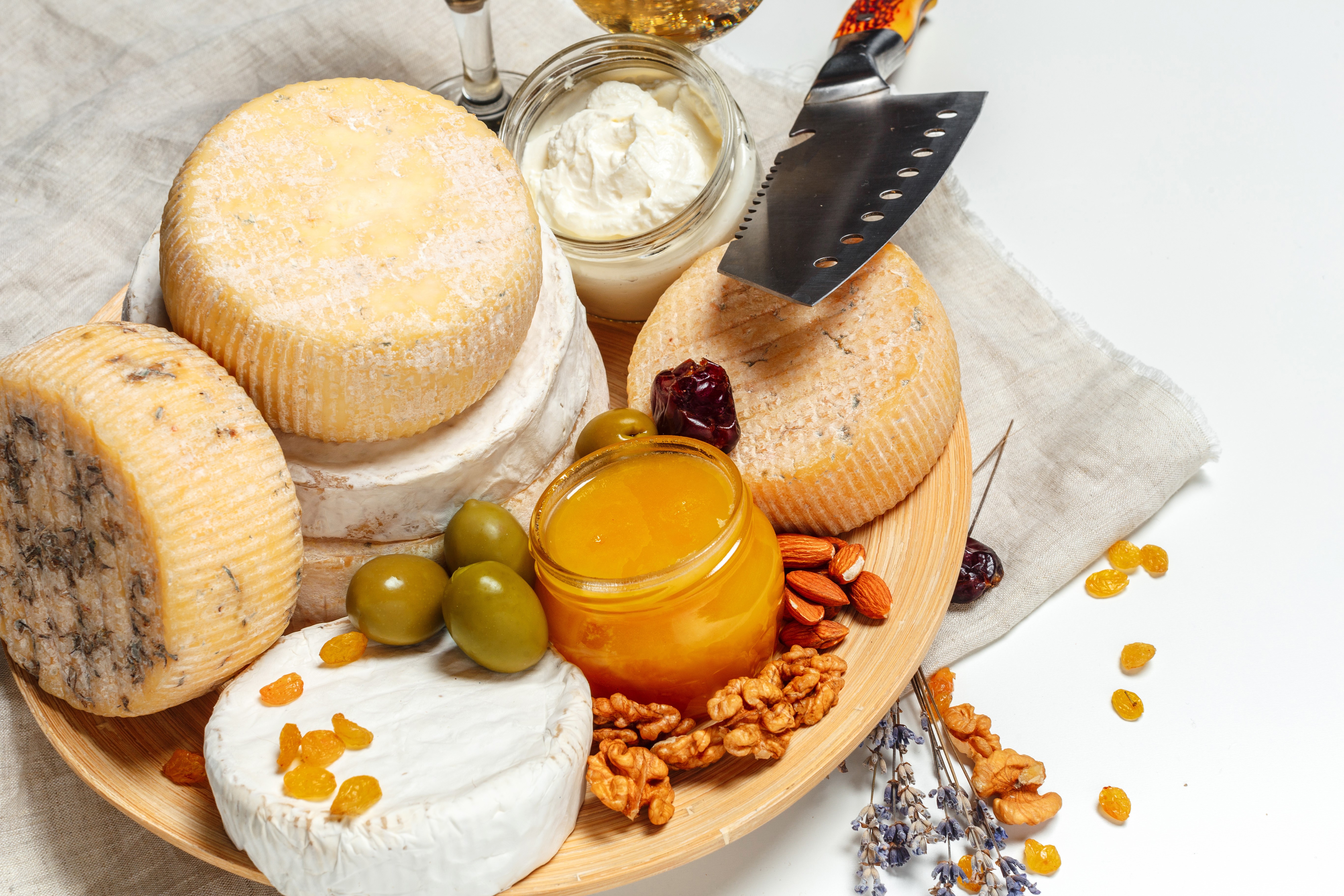 Cheese platter with nuts, olives, and honey HD Wallpaper