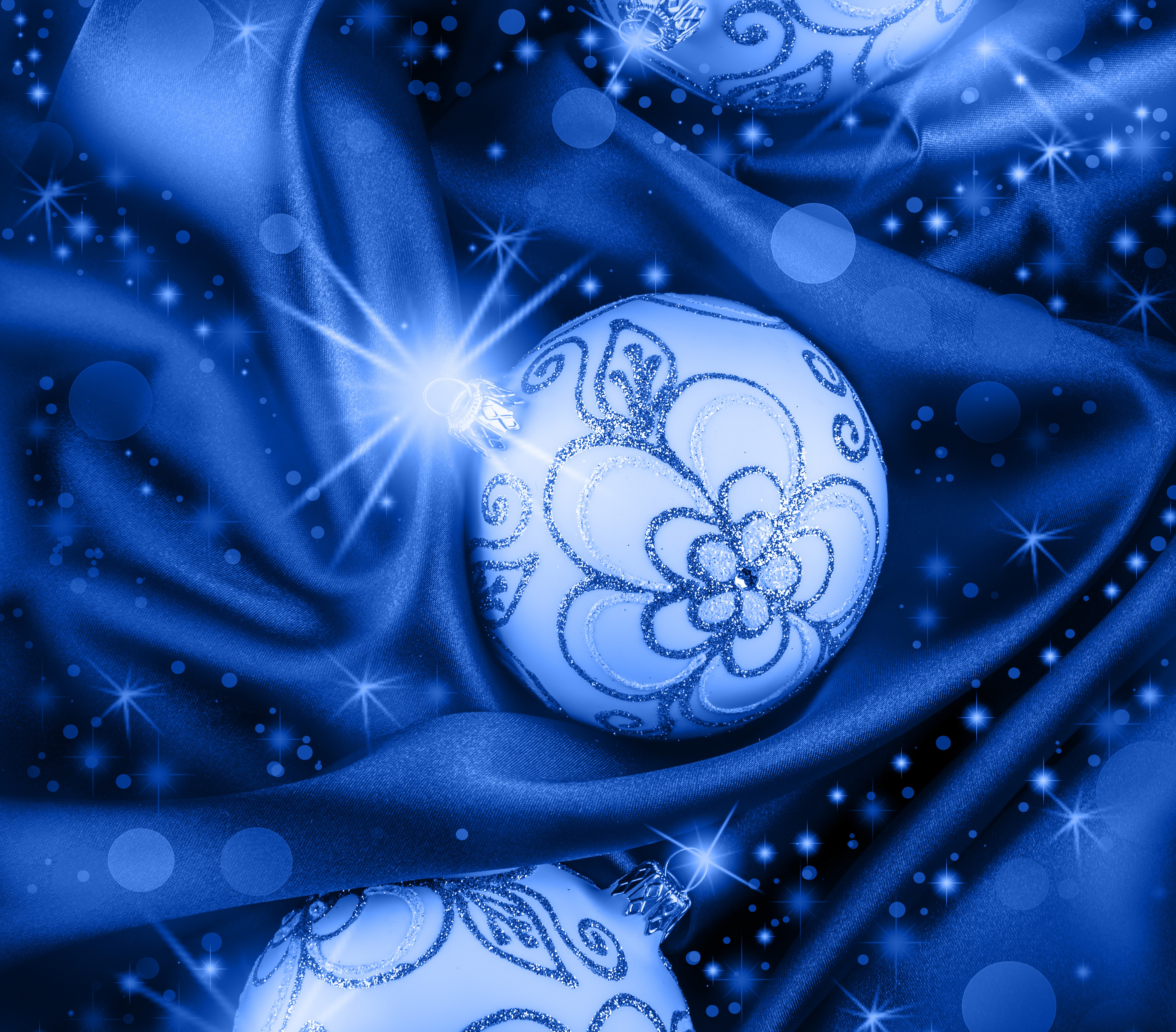 Christmas balls on blue silk with light rays HD Wallpaper