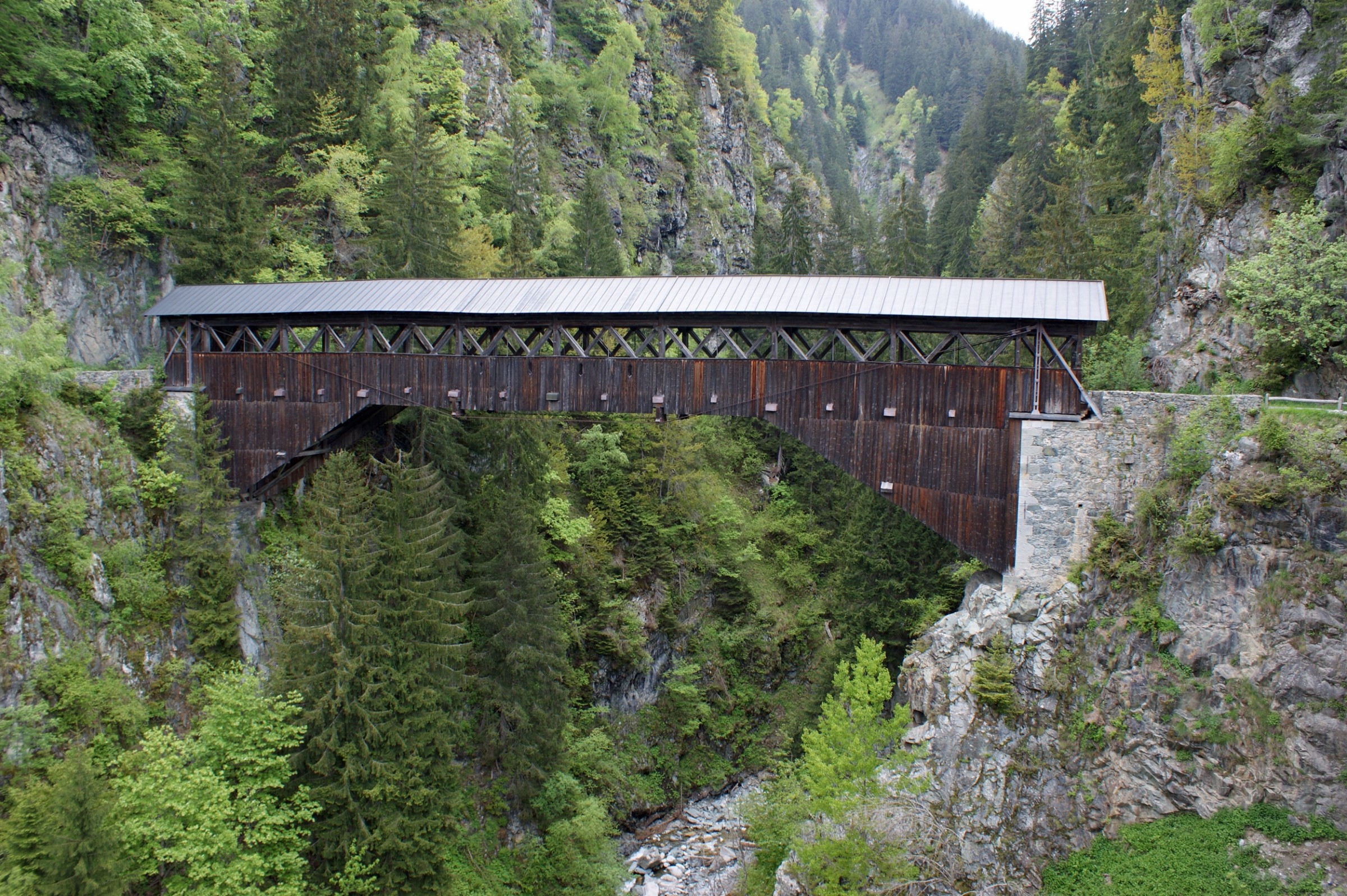 Wooden covered bridge over a gorge in Disentis, Switzerland HD Wallpaper