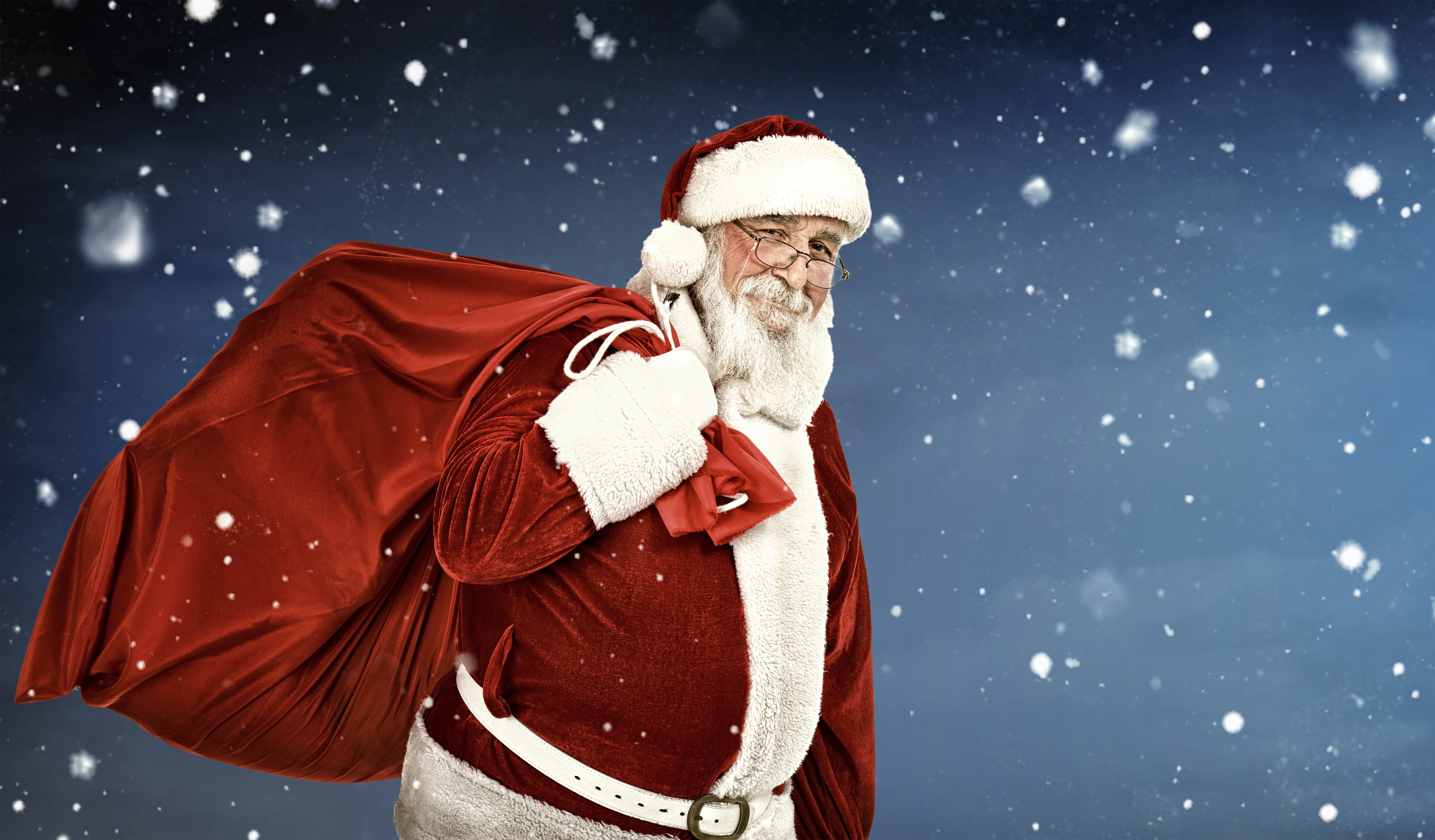 Santa Claus with a sack of gifts in the snow HD Wallpaper