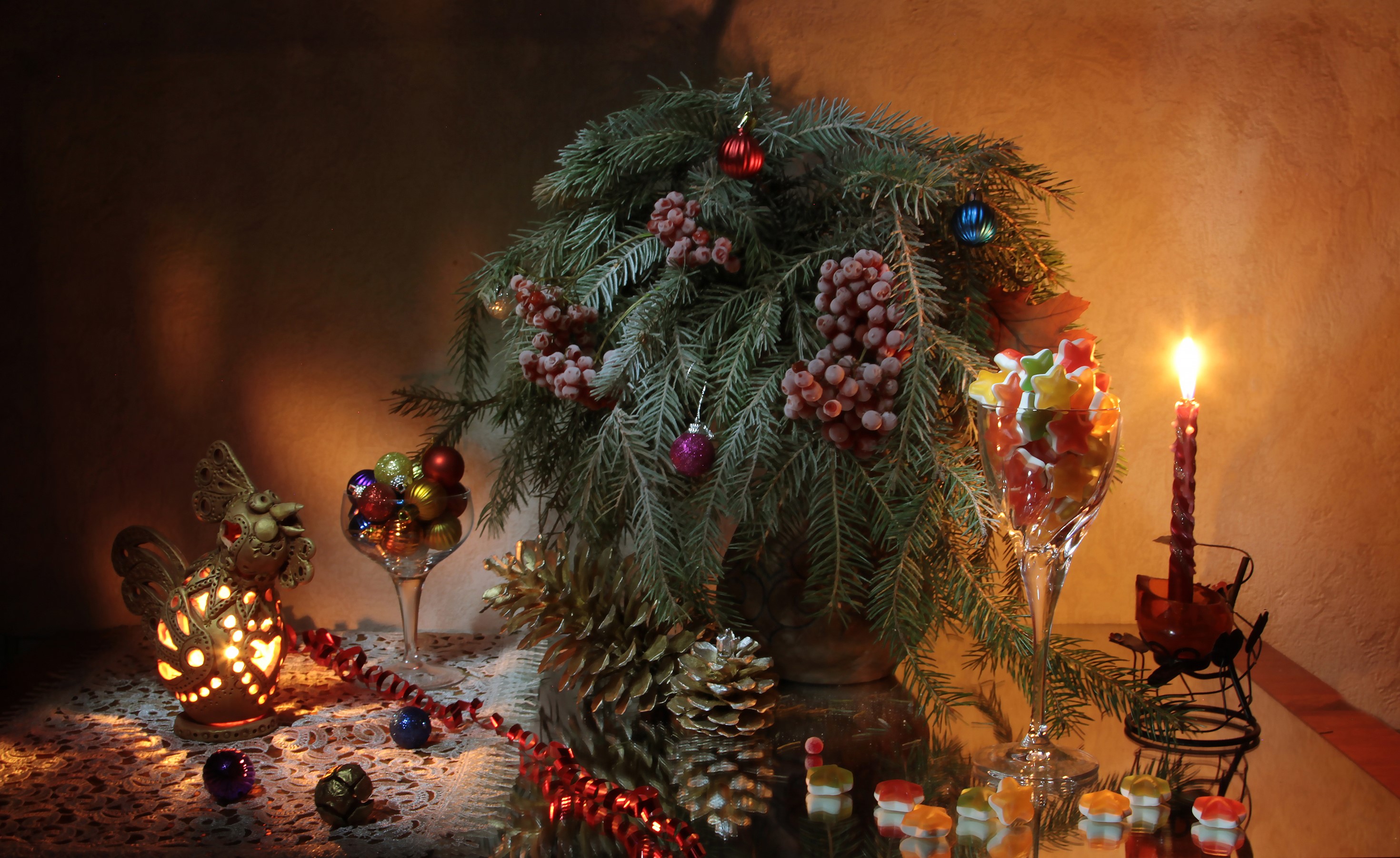 Christmas still life with fir branches, ornaments, candies, and candle HD Wallpaper
