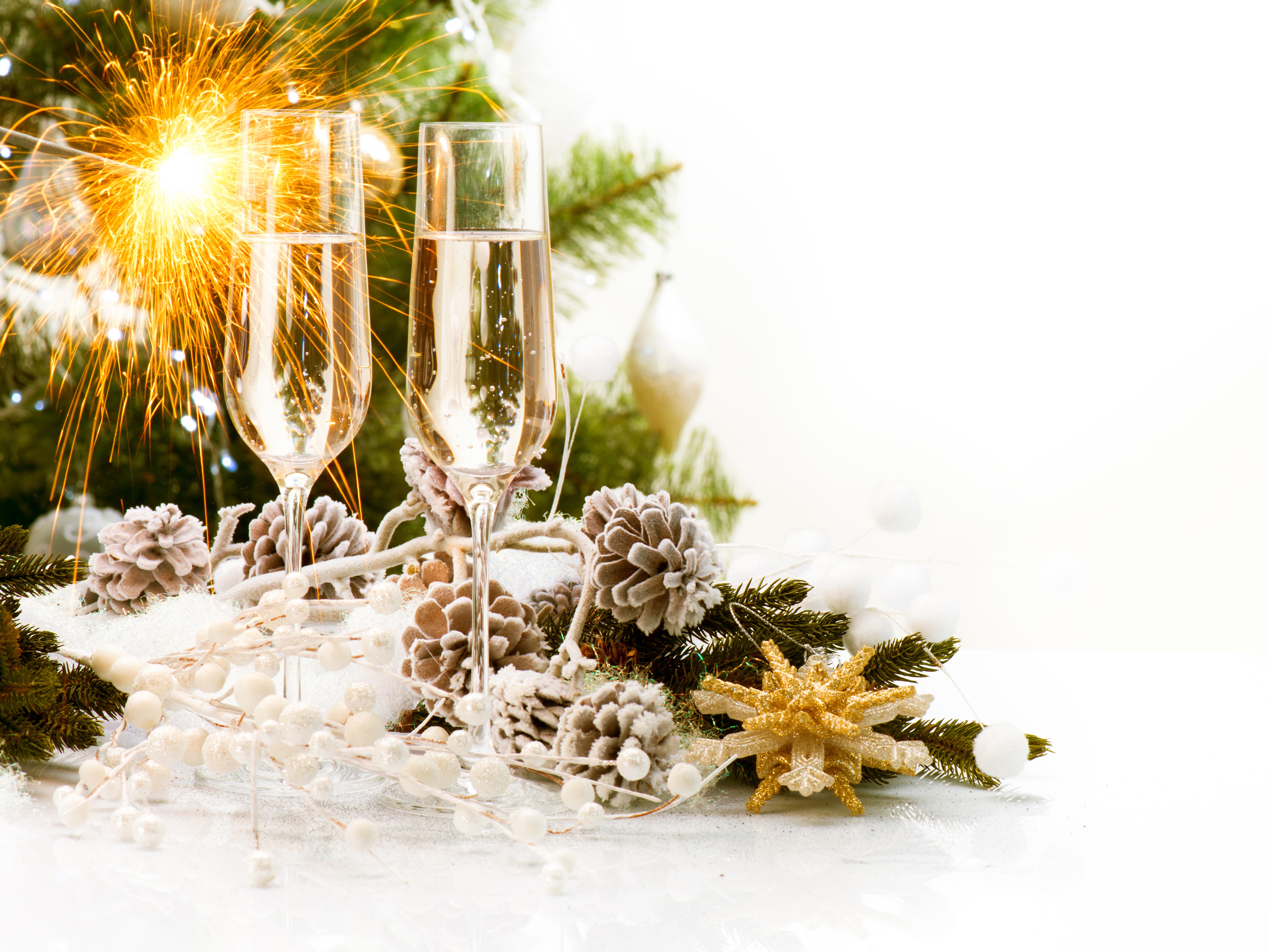 Champagne glasses with sparkler and Christmas decorations HD Wallpaper
