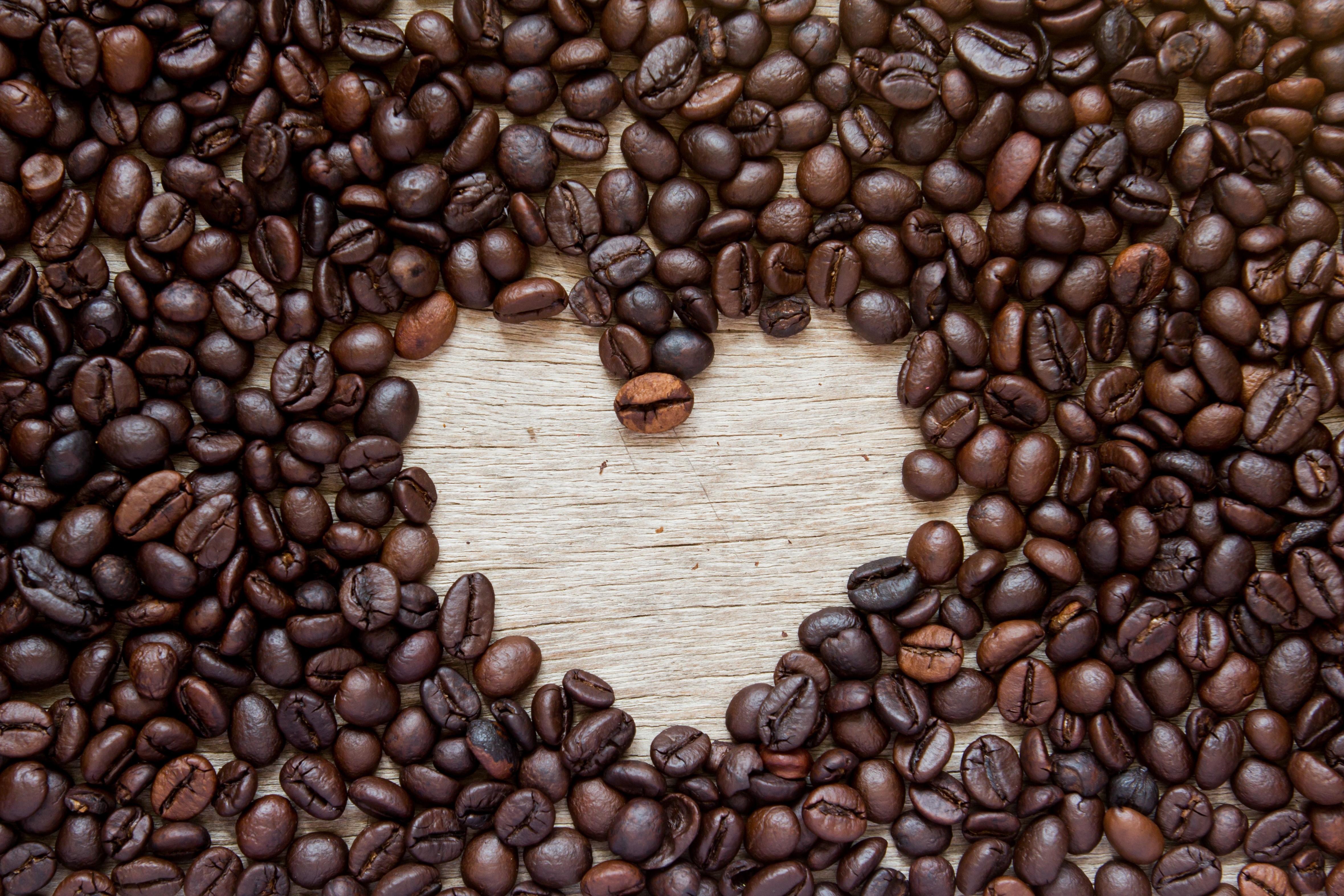 Coffee beans arranged in a heart shape HD Wallpaper