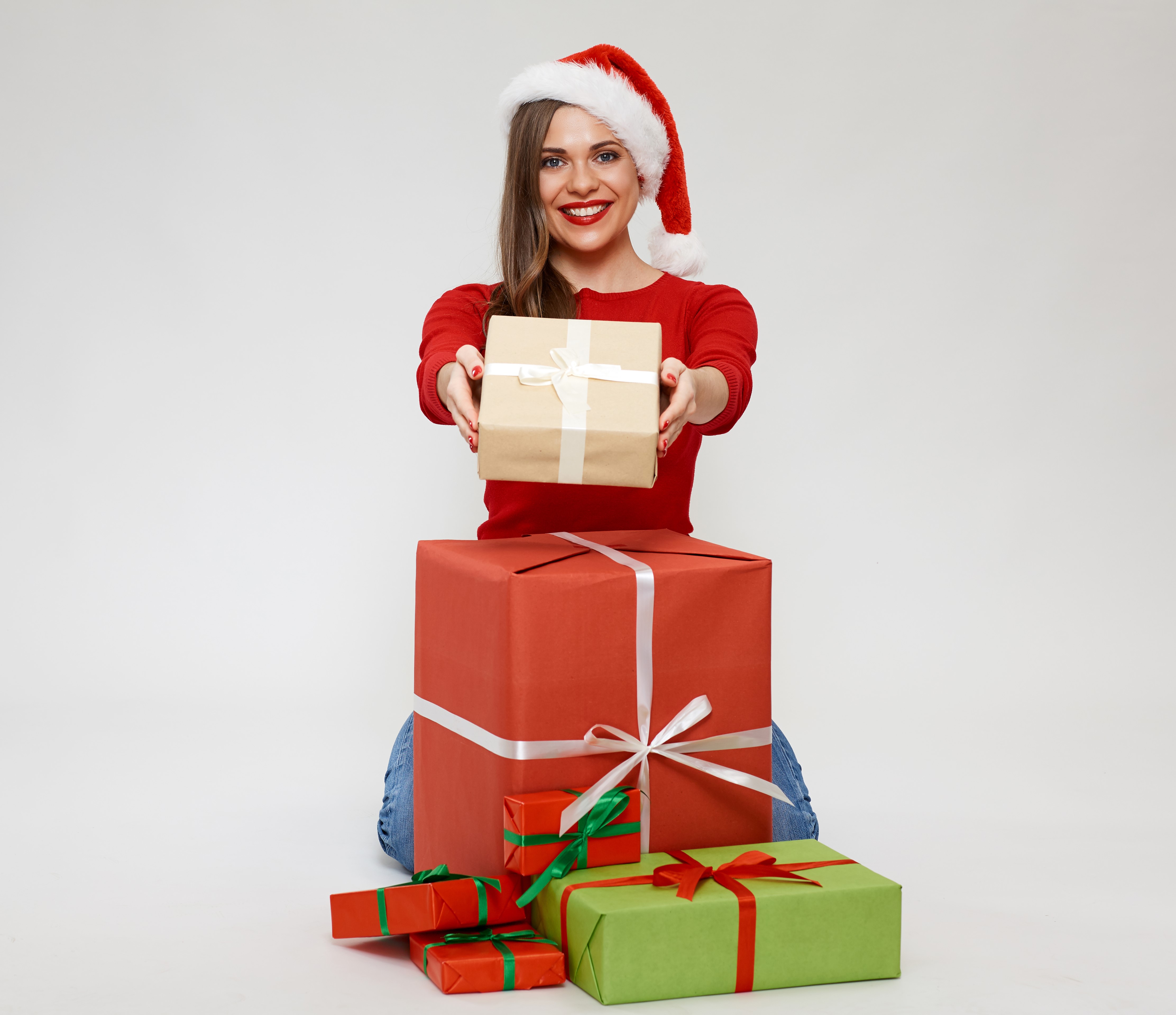 Woman in Santa hat with Christmas gifts HD Wallpaper