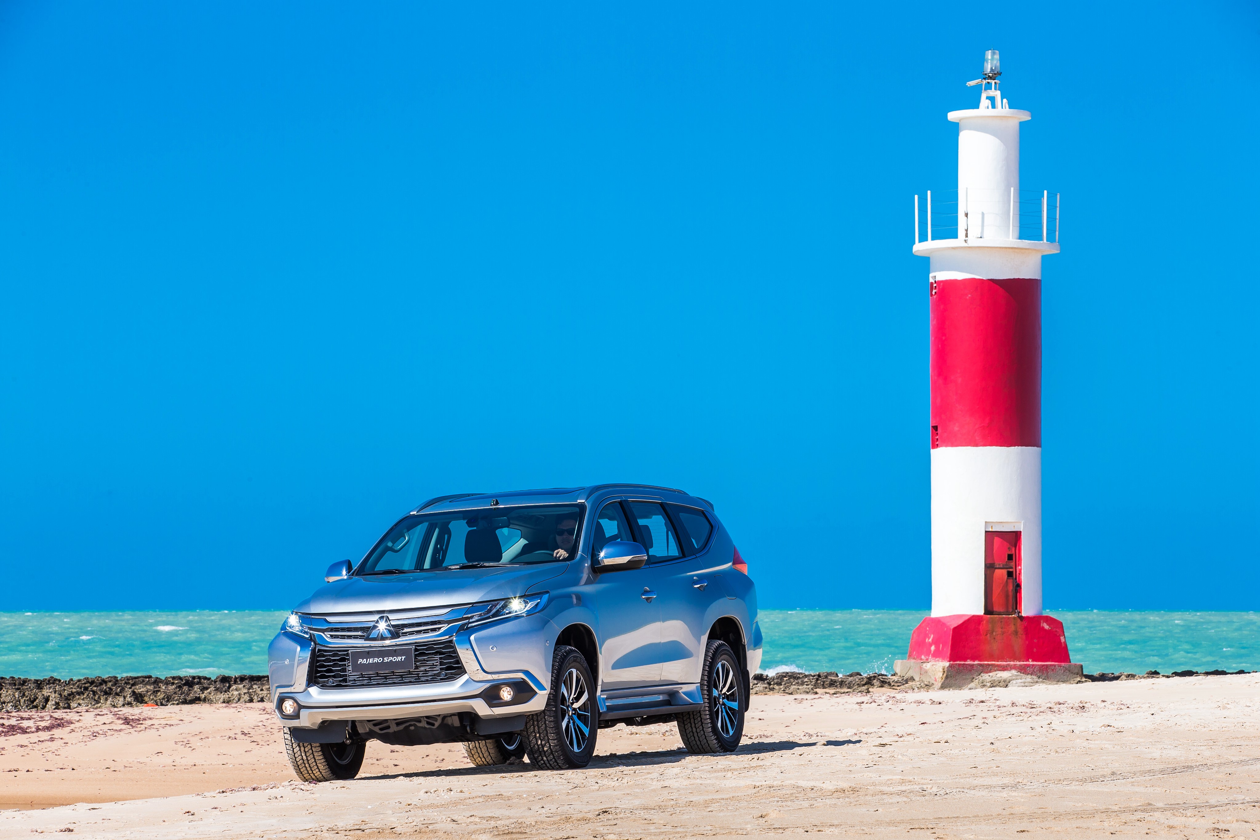 Silver Mitsubishi Pajero Sport near lighthouse HD Wallpaper