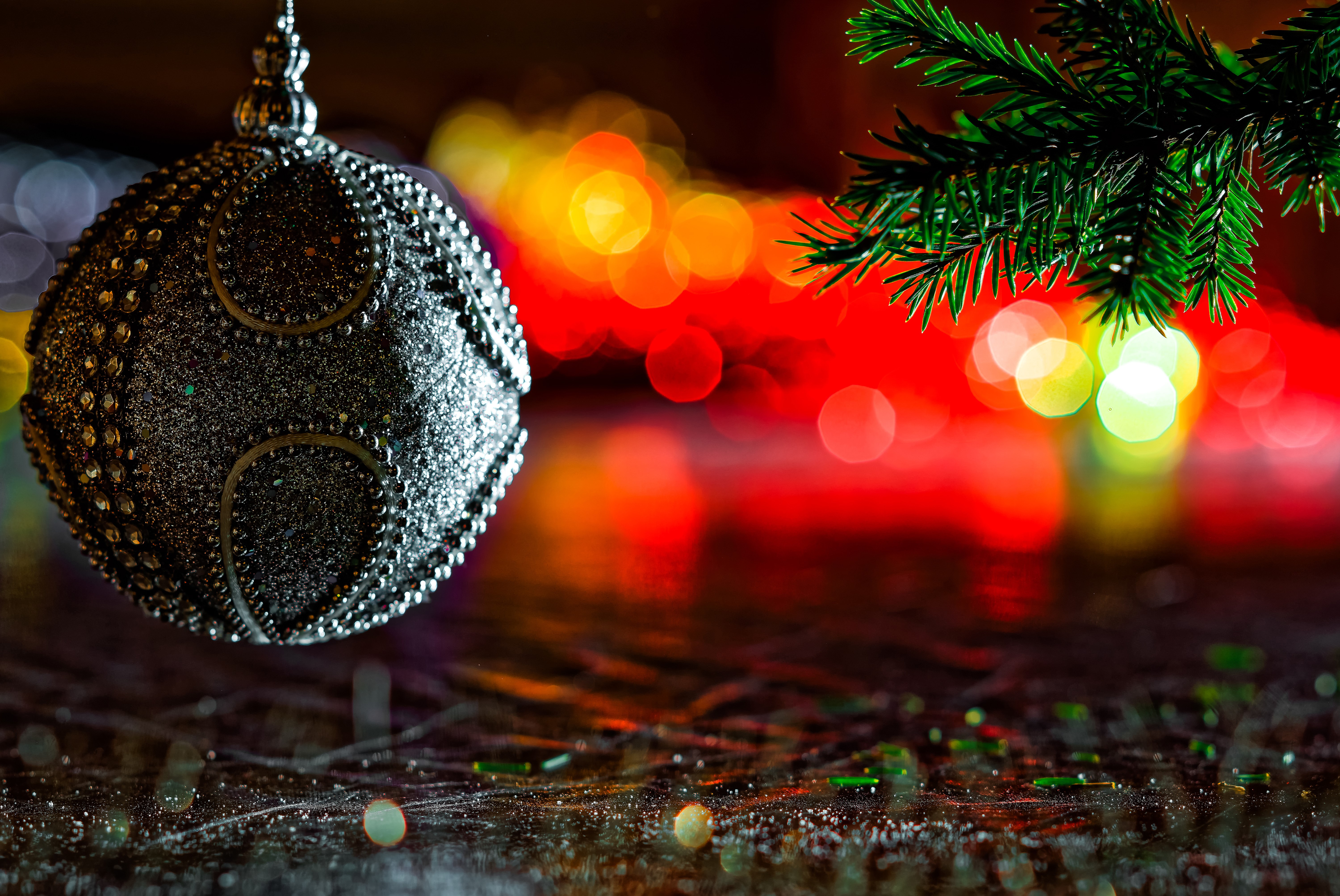 Christmas ornament and pine branch with bokeh lights HD Wallpaper