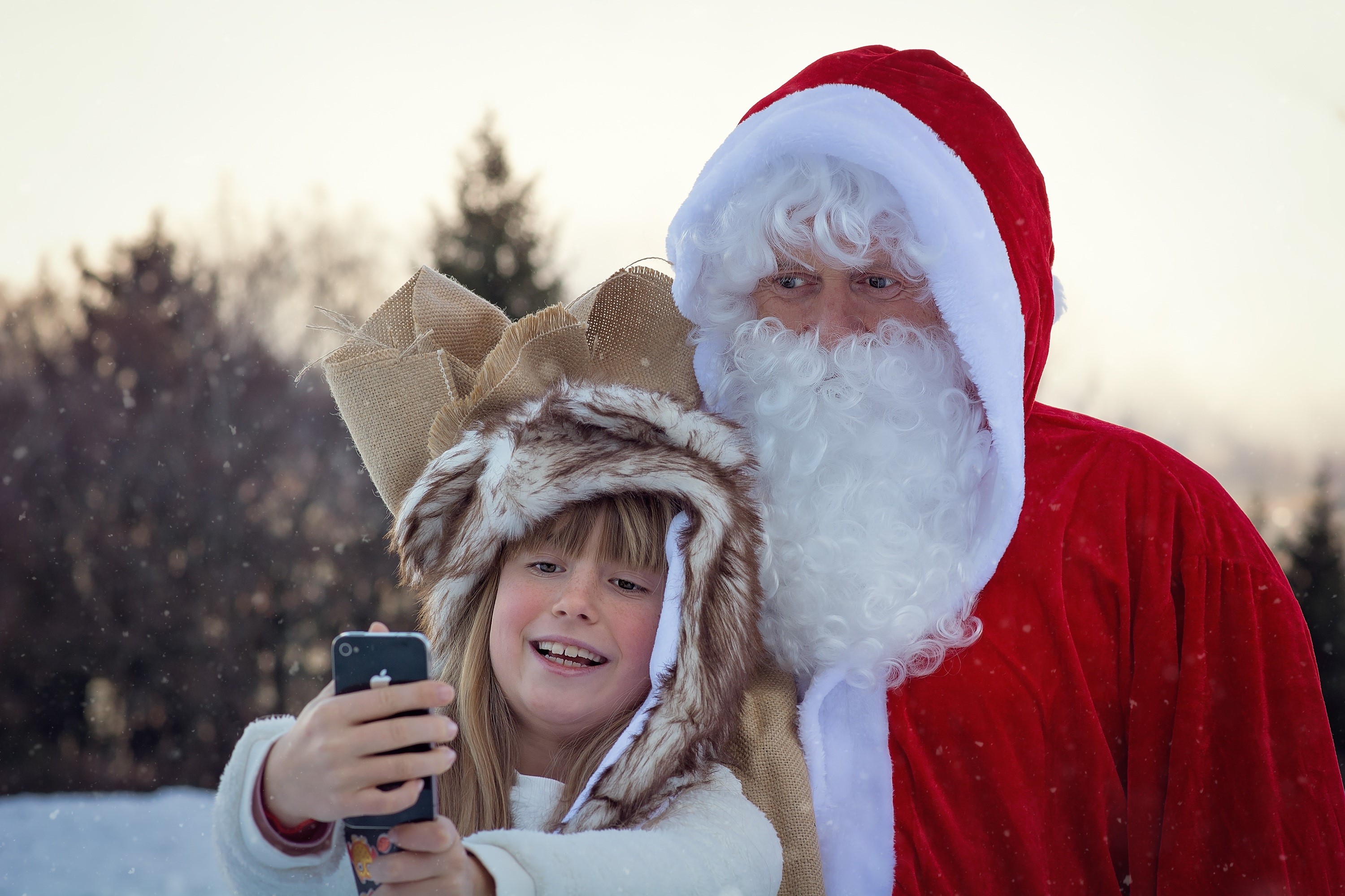 Santa Claus and a girl taking a selfie in winter HD Wallpaper
