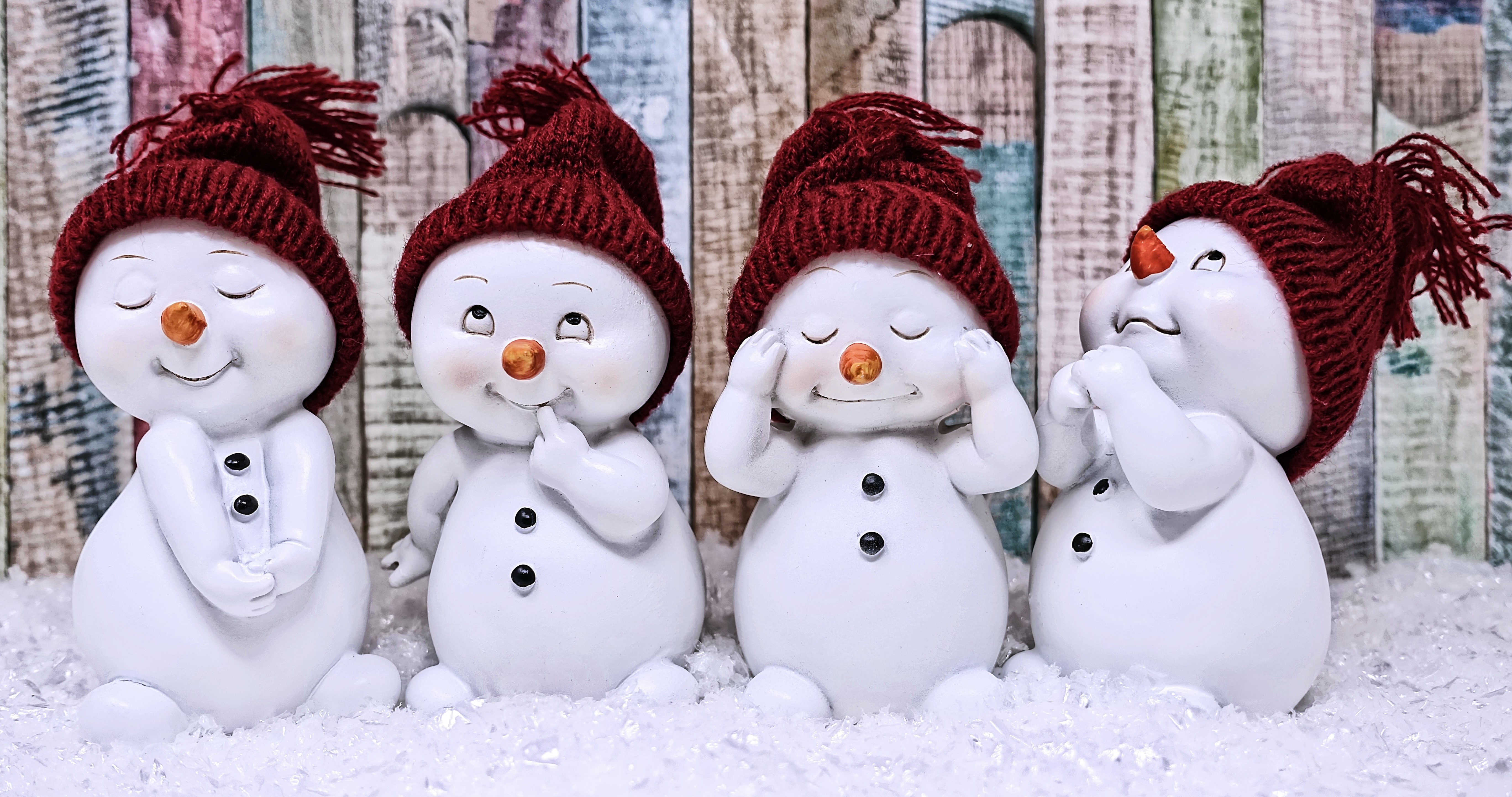 Four snowmen in winter hats HD Wallpaper