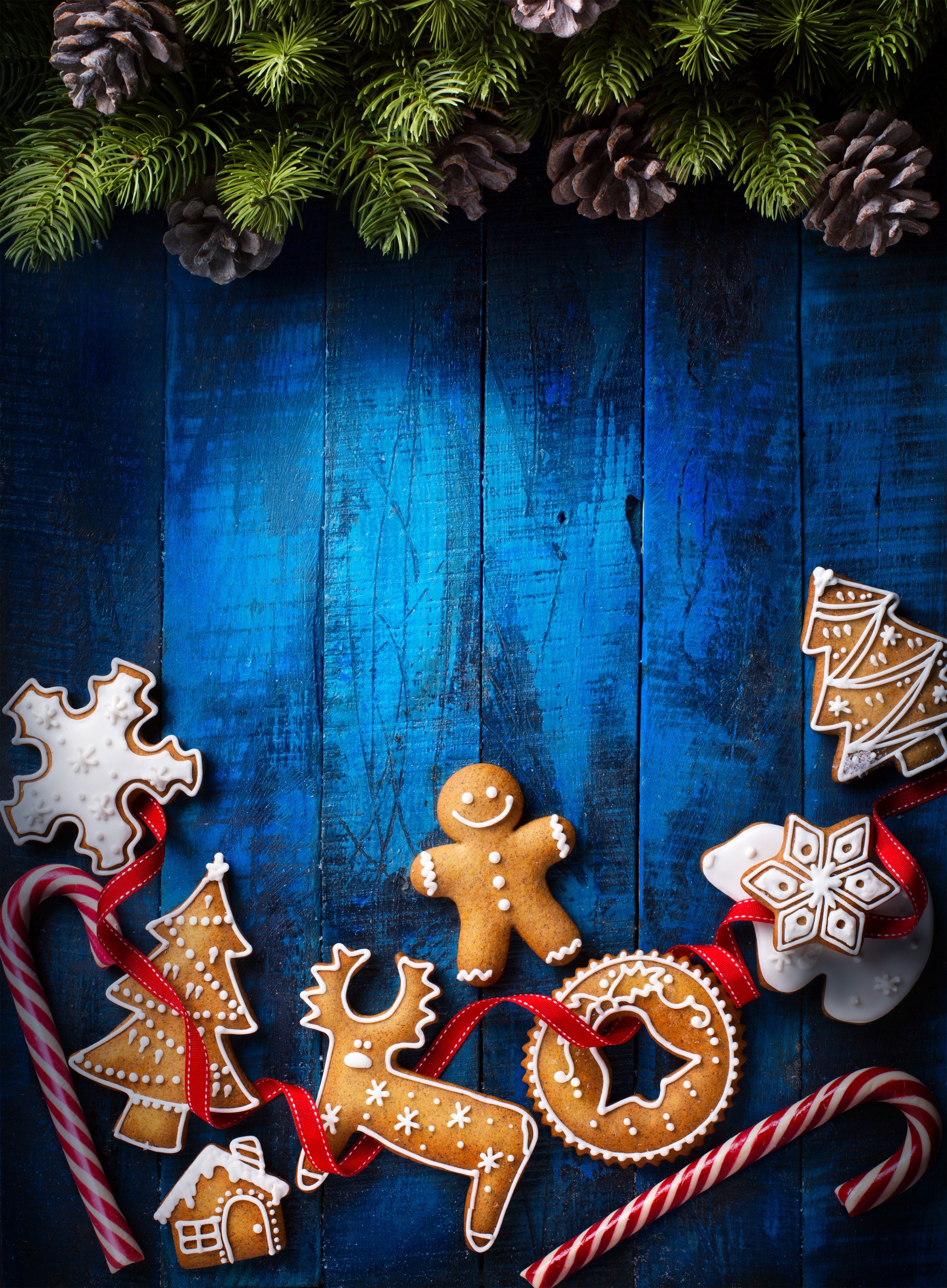 Christmas gingerbread cookies and candy canes on blue wood HD Phone Wallpaper