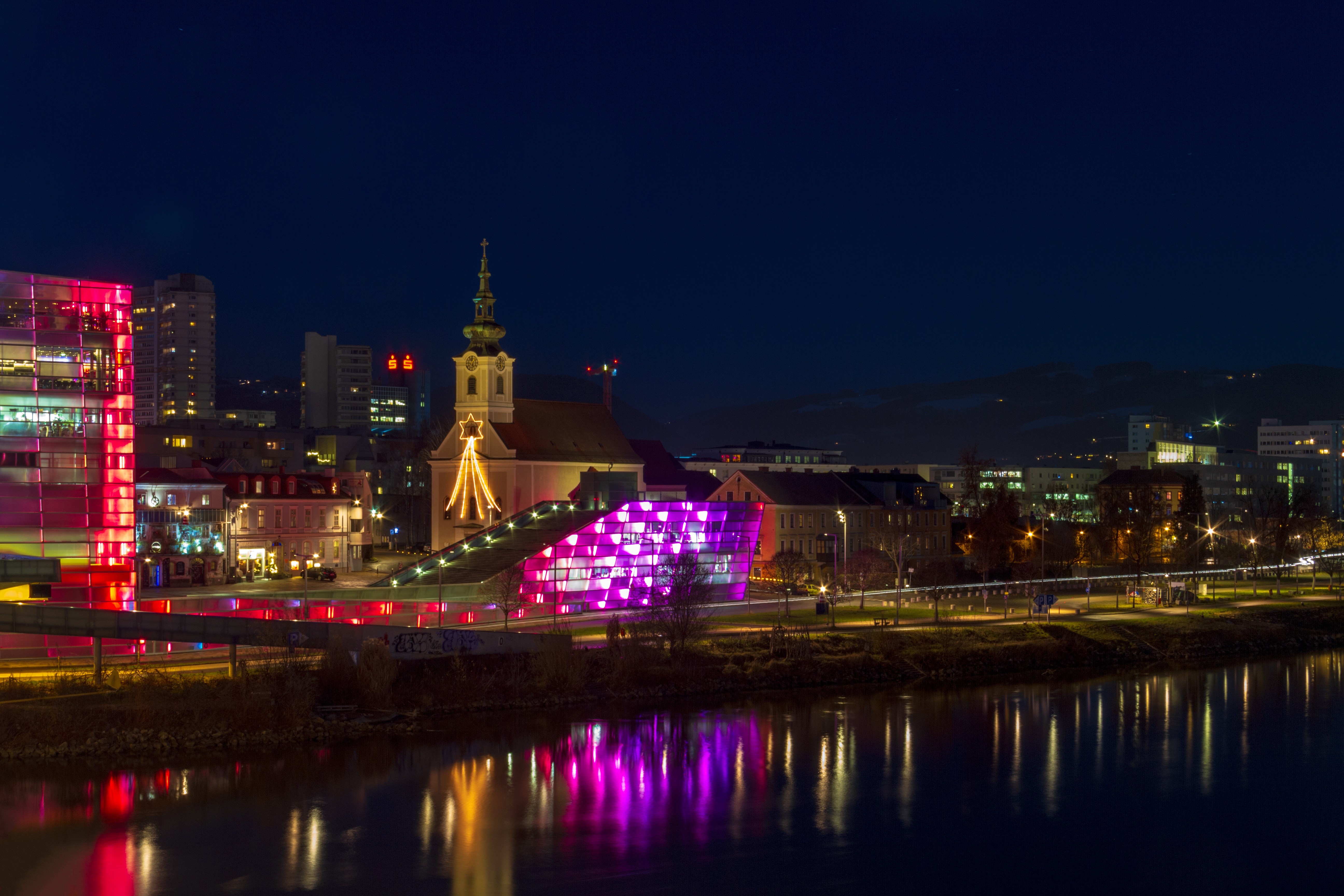 Linz, Austria at Night with Illuminated Buildings and Church HD Wallpaper