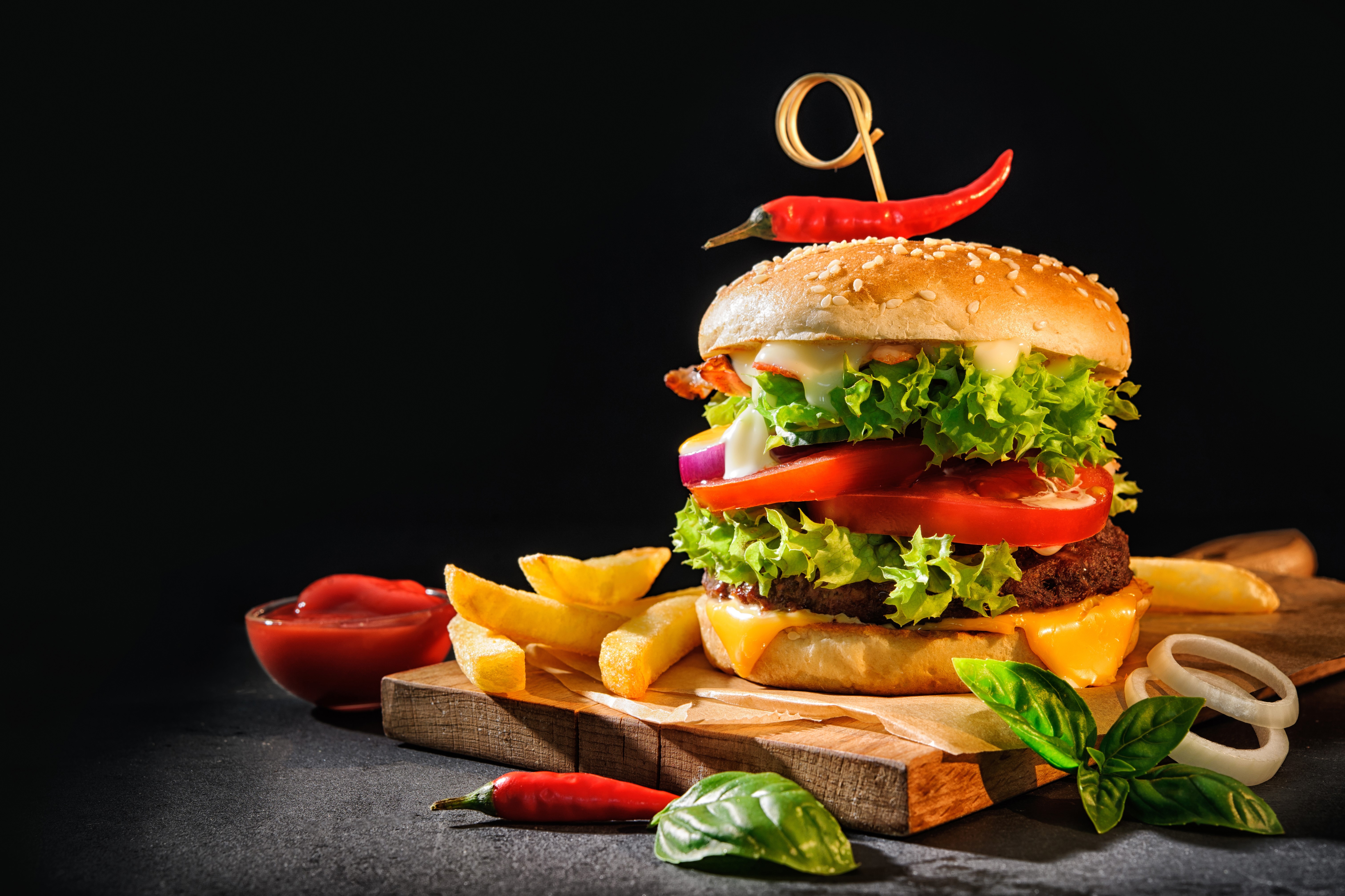 Hamburger with French fries and chili pepper on cutting board HD Wallpaper