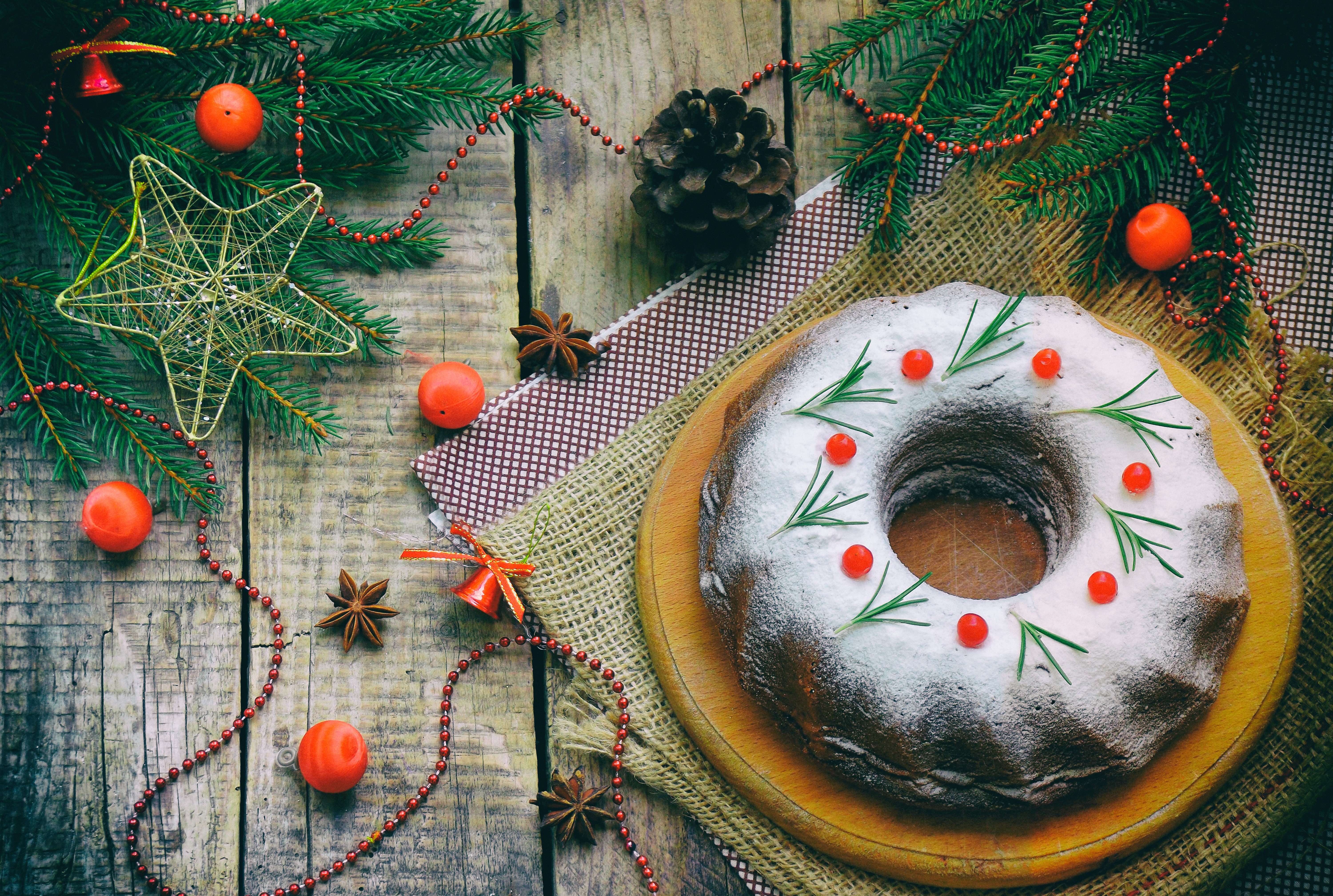 Christmas bundt cake with rosemary and berries on wooden table HD Wallpaper